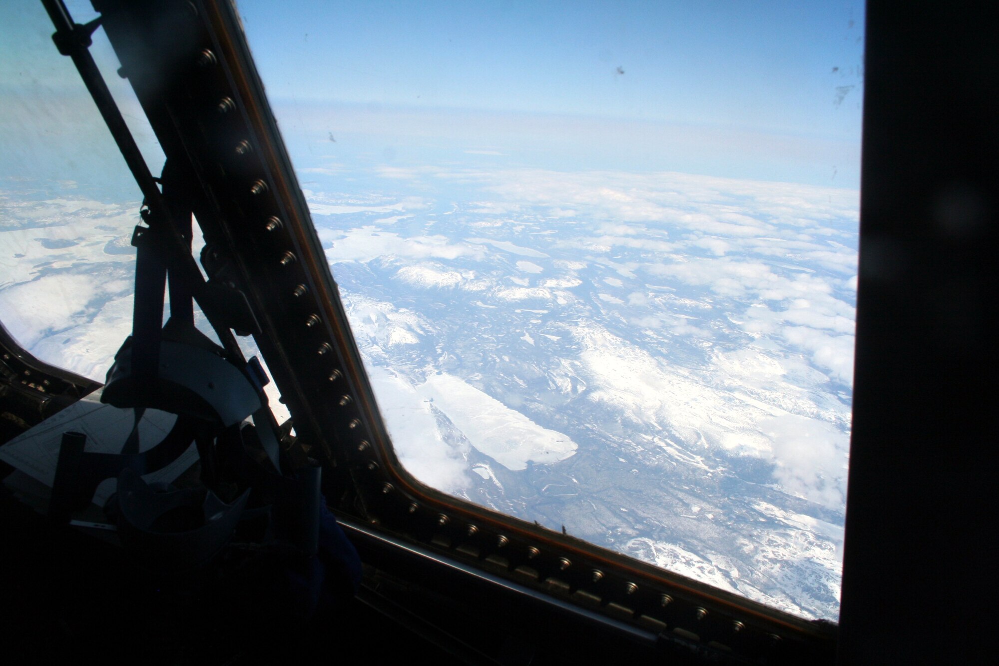 Ice-covered areas are seen from above the Arctic Circle from the window of a C-5M Super Galaxy on a  mission from Dover Air Force Base, Del., on June 5, 2011. The C-5M's mission was to complete the first Arctic overflight from Dover AFB to Bagram Airfield, Afghanistan. The plane successfully landed at Bagram just over 15 hours later on June 6, 2011. (U.S. Air Force Photo/Master Sgt. Scott T. Sturkol)