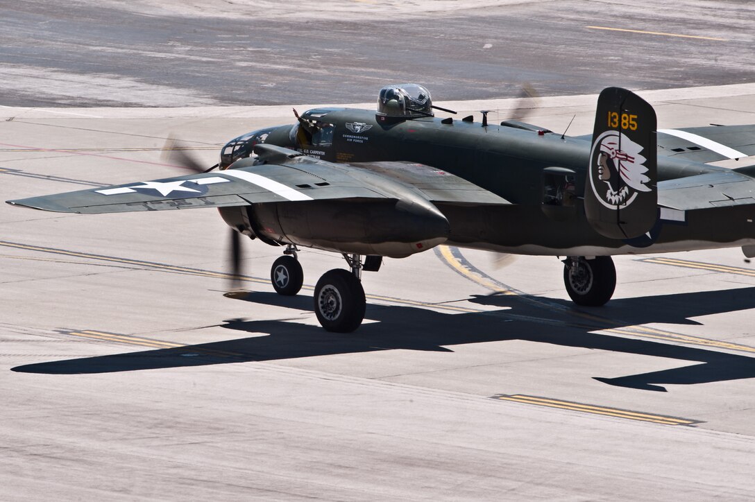 The pilot of a B-25 Mitchell waves to the crowd during the 2011 Dakota Thunder airshow at Ellsworth Air Force Base, S.D., June 4, 2011. Nearly 40,000 people of all ages and walks of life converged here to watch the vast array of aerial demonstrations and view numerous static aircraft. (U.S. Air Force photo/Tech. Sgt. Nathan Gallahan)