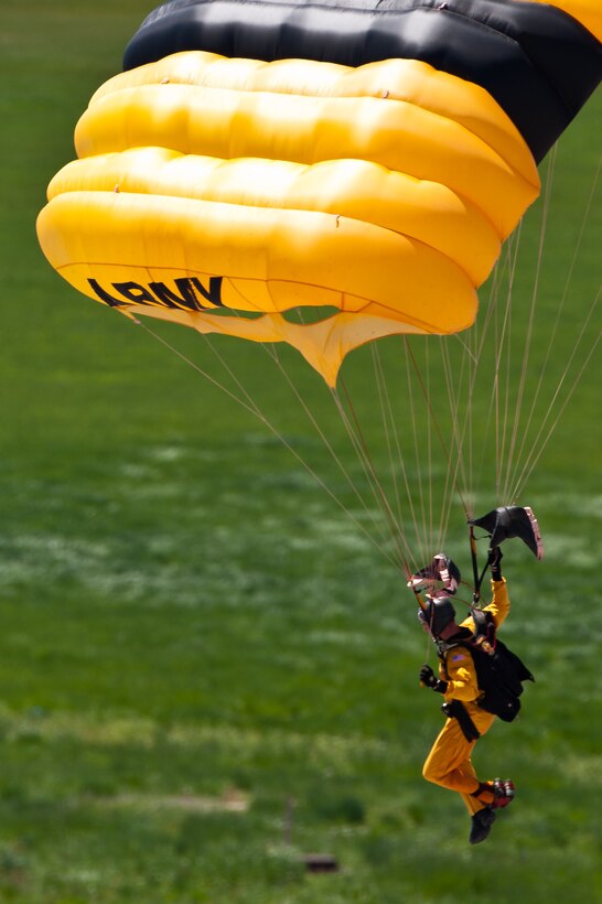 A U.S. Army Golden Knights parachutes team member soars above the crowd attending the 2011 Dakota Thunder Airshow at Ellsworth Air Force Base, S.D., June 4, 2011. Nearly 40,000 people of all ages and walks of life converged here to watch the vast array of aerial demonstrations and view numerous static aircraft. (U.S. Air Force photo/Tech. Sgt. Nathan Gallahan)