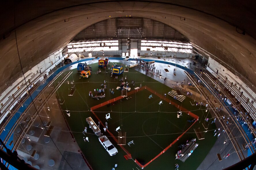 People file through the Pride Hangar at Ellsworth Air Force Base, S.D., June 4, 2011 to visit the 2011 Dakota Thunder airshow. Nearly 40,000 people of all ages and walks of life converged here to watch the vast array of aerial demonstrations and view numerous static aircraft. (U.S. Air Force photo/Tech. Sgt. Nathan Gallahan)