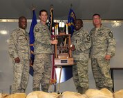 Chief Master Sgt. Kenneth Lilly, 23rd Maintenance Group, and Tech Sgt. Joel Remsnyder, 23rd Aircraft Maintenance Squadron  accepts  the Weapons Load Team of the Year award on behalf of Staff Sgt. Kyle Blouin, Senior Airman Christopher Tarbart and Airman 1st Class Corey Lillberg, 74th Aircraft Maintenance Unit, at Moody Air Force Base, Ga.,  June 2. This award is given each year to the best load team, which is determined by competitions held throughout the year. (U.S. Air Force photo/Senior Airman Stephanie Mancha)(RELEASED)