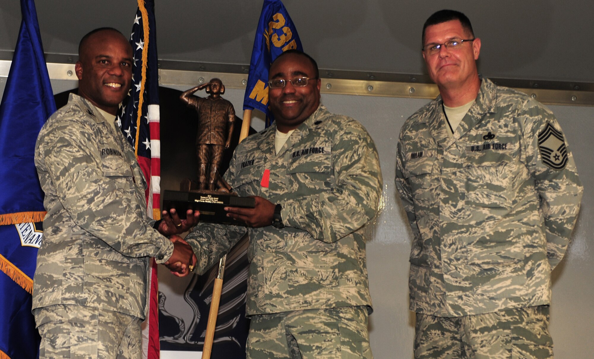 Lt. Col. John Frazier, 723rd Aircraft Maintenance Squadron commander, receives the Chief Master Sgt of the Air Force Thomas Barnes Crew Chief of the Year Award on behalf of Staff Sgt. Cevin Medley, 723rd AMXS member, at Moody Air Force Base, Ga., June 2. The award is given annually to Airmen the Air Force Association recognizes as having given the most significant contribution to the Air Force mission. (U.S. Air Force photo/Senior Airman Stephanie Mancha)(RELEASED)
