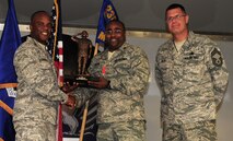Lt. Col. John Frazier, 723rd Aircraft Maintenance Squadron commander, receives the Chief Master Sgt of the Air Force Thomas Barnes Crew Chief of the Year Award on behalf of Staff Sgt. Cevin Medley, 723rd AMXS member, at Moody Air Force Base, Ga., June 2. The award is given annually to Airmen the Air Force Association recognizes as having given the most significant contribution to the Air Force mission. (U.S. Air Force photo/Senior Airman Stephanie Mancha)(RELEASED)