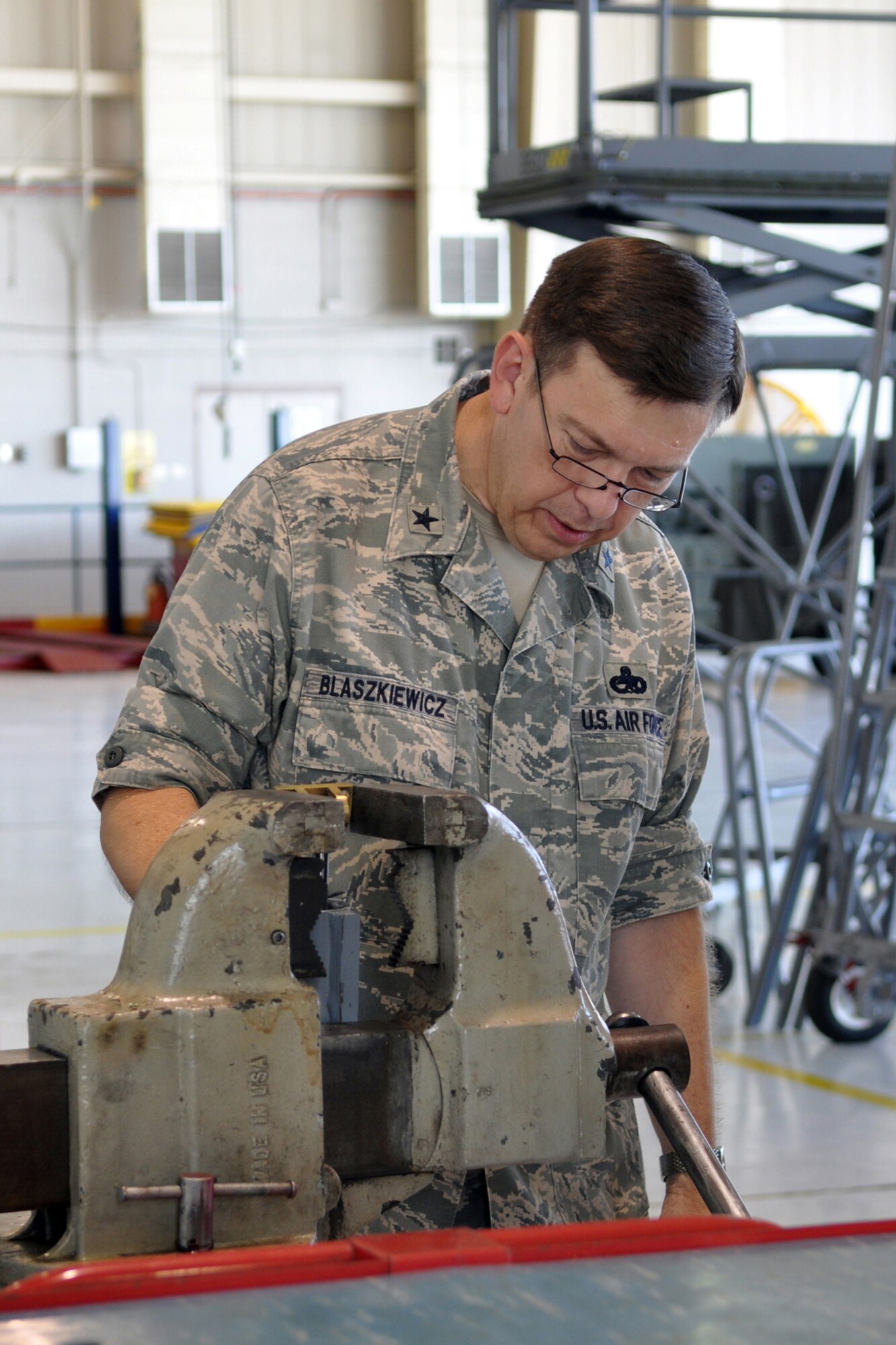 Brig. Gen. Gary Blaszkiewicz, the director of logistics for Air Force Reserve Command, examines a longitudinal cylinder from a MHU-83 D/E bomb lifter that AGE is performing an efficiency report on during his familiarization visit to the 307th Bomb Wing and 917th Fighter Group at Barksdale Air Force Base, La., June 4, 2011. (U.S Air Force photo by Master Sgt. Mary Hinson)