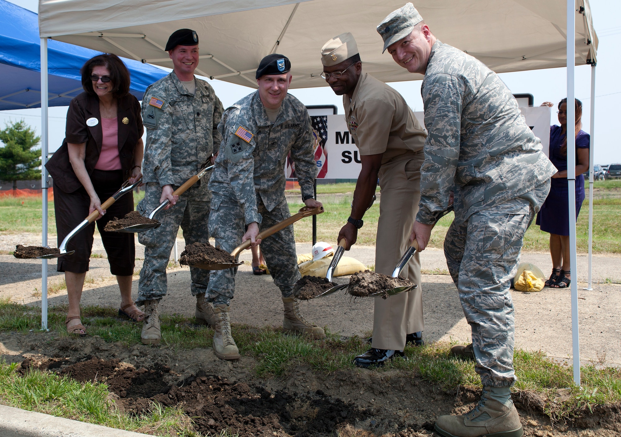 (Left to Right) Joan Cole, Military and Family Support Center chief; Army Lt. Col. Michael Clancy, New York District’s U.S. Army Corps of Engineers deputy commander; Col. Joseph Poth, Joint Base McGuire-Dix-Lakehurst deputy commander; Command Master Chief Herbert Kelton, Naval Support Activity-Lakehurst command master chief; and Lt. Col. John Barlett, 87th Force Support Squadron commander break ground at the new MFSC site Wednesday. (U.S. Air Force photo by Wayne Russell/Released)
