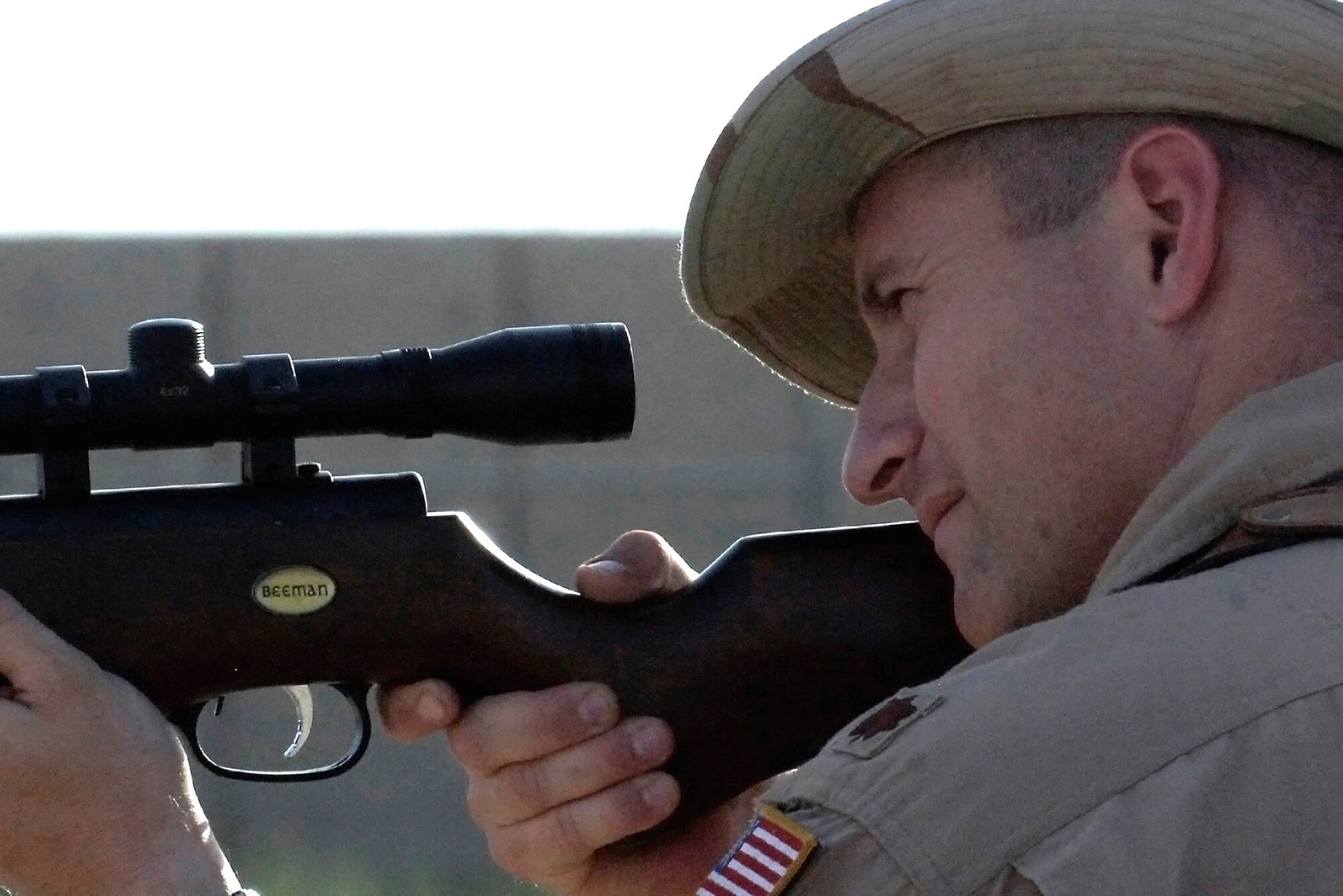 Maj. David Aumack takes aim at a bird June 3, 2011, as part of the Bird/Wildlife Aircraft Strike Hazard program at Baghdad International Airport. The BASH program is designed to reduce wildlife hazards by keeping birds and other animals away from runways and planes. Major Aumack is a flight safety officer assigned to the 321st Air Expeditionary Wing. (U.S. Air Force photo/Tech. Sgt. Randy Redman)