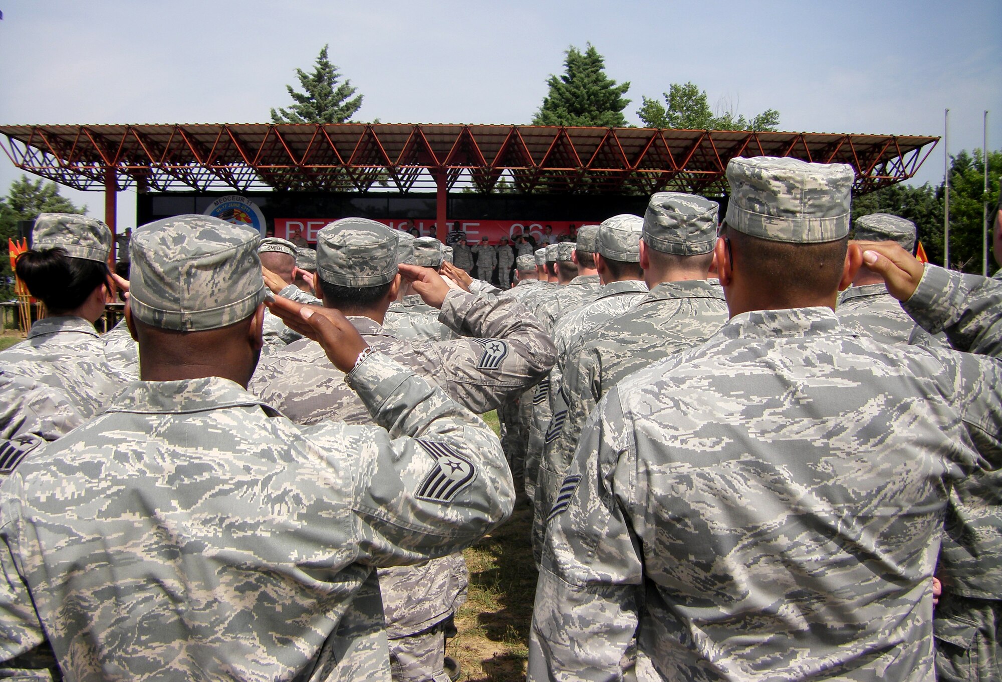 CAMP PEPELISHTE, Macedonia -- Members of the U.S. Air Force and Army salute during the Macedonian and American National Anthems at the opening ceremony of Medical Training Exercise in Central and Eastern Europe 2011 here June 6. The countries participating in this year’s MEDCEUR are Macedonia, Montenegro, Bosnia and Herzegovina, Serbia, Slovenia, Norway and the United States. MEDCEUR is a Partnership for Peace and chairman of the Joint Chiefs of Staff-sponsored regional and multilateral exercise in Central and Eastern Europe designed to provide medical training and operational experience in a deployed environment.  (U.S. Air Force photo/Master Sgt. Kelley J. Stewart)