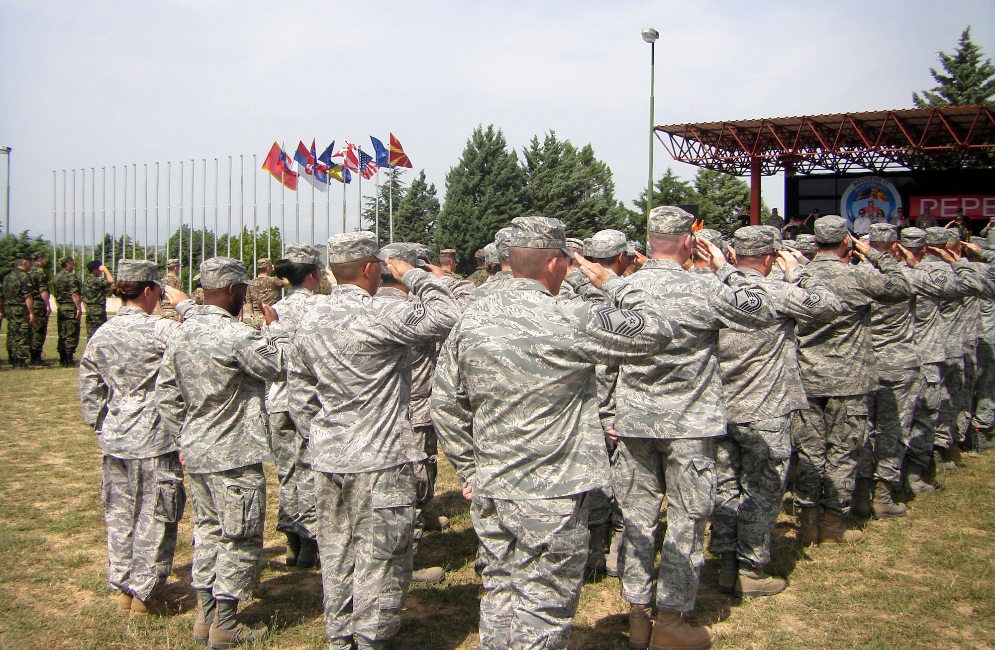 CAMP PEPELISHTE, Macedonia -- Members of the United States Air Force and Army salute during the Macedonian and American National Anthems at the opening ceremony of Medical Training Exercise in Central and Eastern Europe 2011 here June 6.  The countries participating in this year’s MEDCEUR are Macedonia, Montenegro, Bosnia and Herzegovina, Serbia, Slovenia, Norway and the United States.  MEDCEUR is a Partnership for Peace and chairman of the Joint Chiefs of Staff-sponsored regional and multilateral exercise in Central and Eastern Europe designed to provide medical training and operational experience in a deployed environment.  (U.S. Air Force photo/Master Sgt. Kelley J. Stewart)