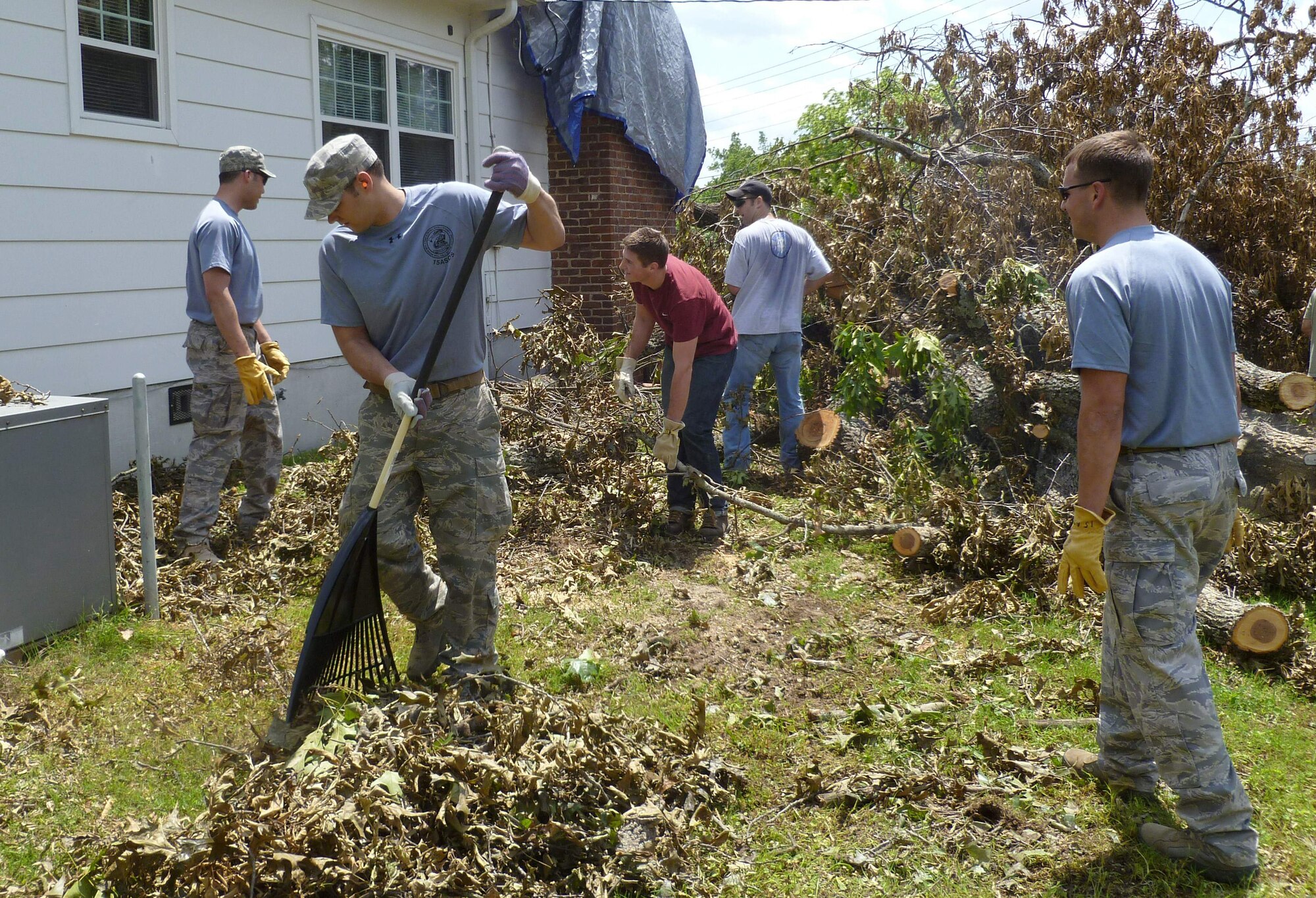 Airmen from the 15th and 165th Air Support Operations Squadrons remove tree debris that damaged the home of Bobbie Citty, an East Ridge, Tenn., resident who's home was damaged by tornadoes April 25 through 28 2011. (U.S. Air Force photo/Chief Master Sgt. Mark Ericson)

