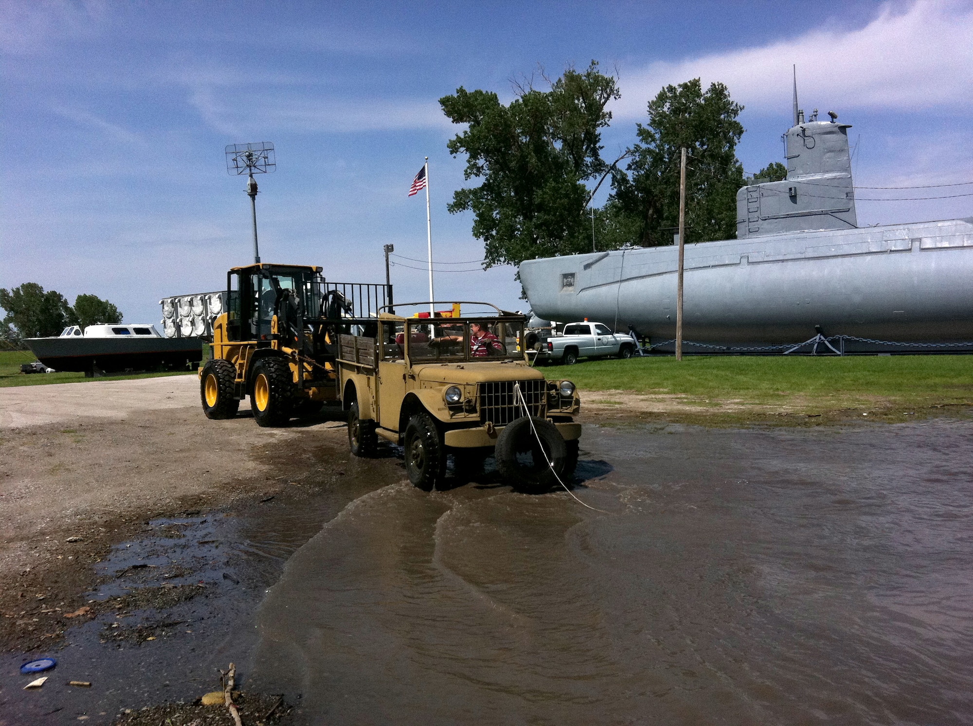 OMAHA, Neb. -- Larry Simbro and Michael Wangberg, heavy equipment operators with the 55th Logistics Readiness Squadron, move items out of oncoming flood waters at Freedom Park here June 1. Freedom Park is an outdoor museum that features numerous military exhibits and has been overcome by rising waters of the Missouri River. Four members of the 55th LRS joined with other members of Team Offutt to move museum artifacts to higher ground until the flood waters recede. (U.S. Air Force photo by Maj. Melvin Maxwell)