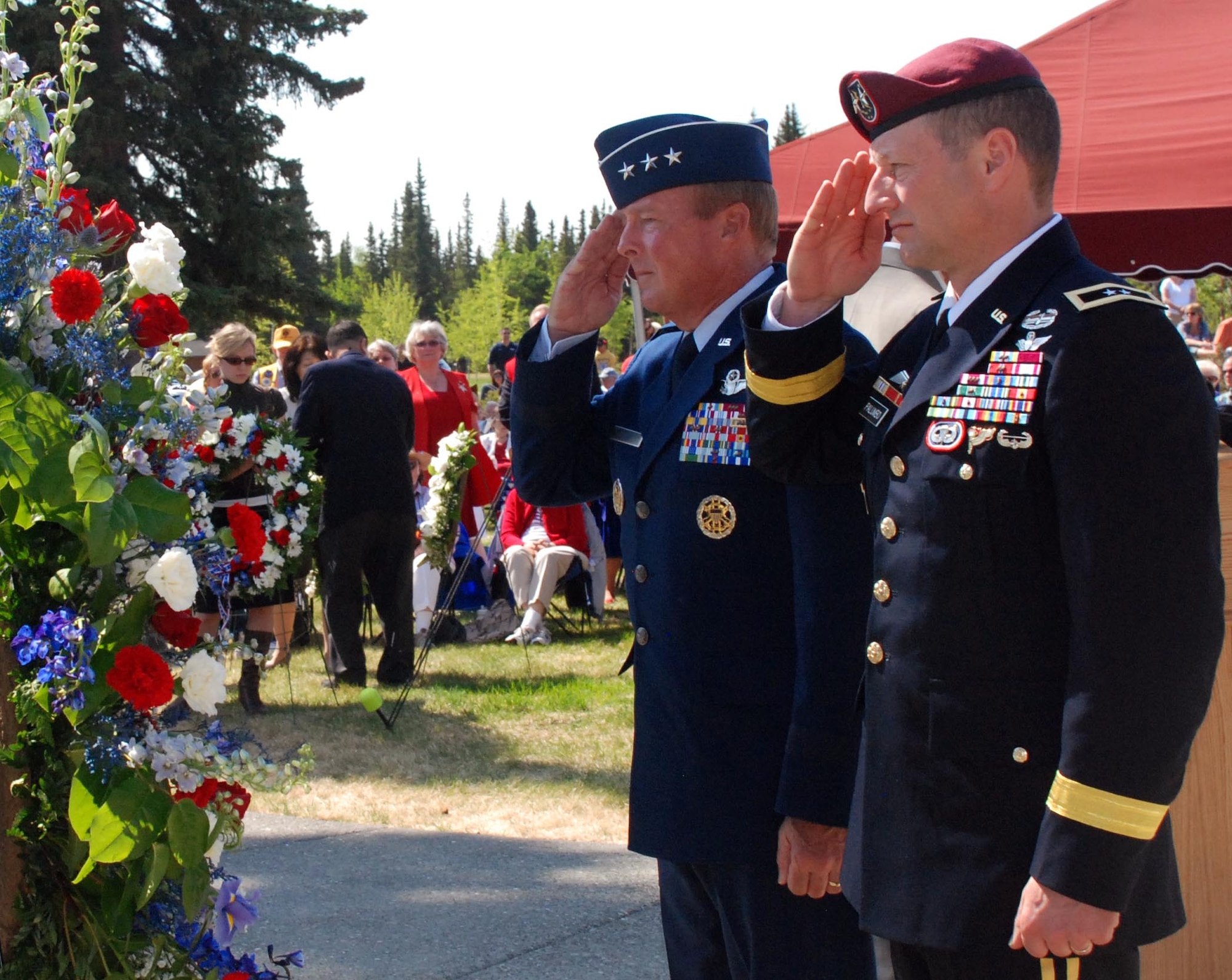 Alaskan Command Commander Air Force Lt. Gen. Dana Atkins and U.S. Army Alaska Commanding General Army Maj. Gen. Raymond Palumbo salute following the presentation of a wreath, Monday, at the Fort Richardson National Cemetery Memorial Day ceremony. (Photo by Mary Rall/USARAK PA)
