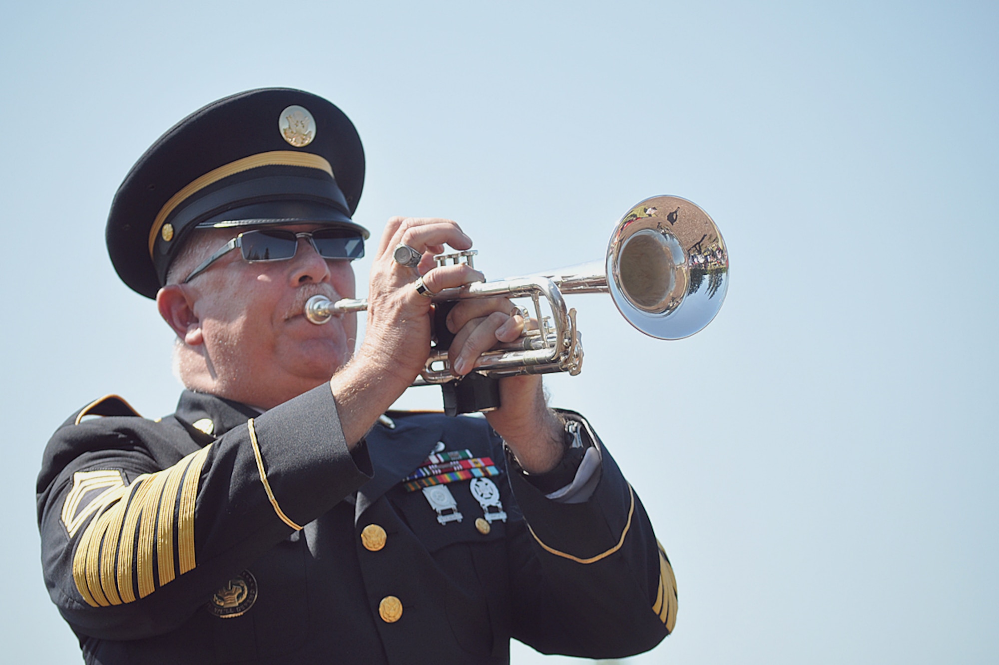 Retired Army Master Sgt. Michael Baty plays Taps as part of the Bugles Across America presentation at Monday's Memorial Day ceremony at the Fort Richardson National Cemetery.  (Air Force photo by John Pennell/JBER PA)