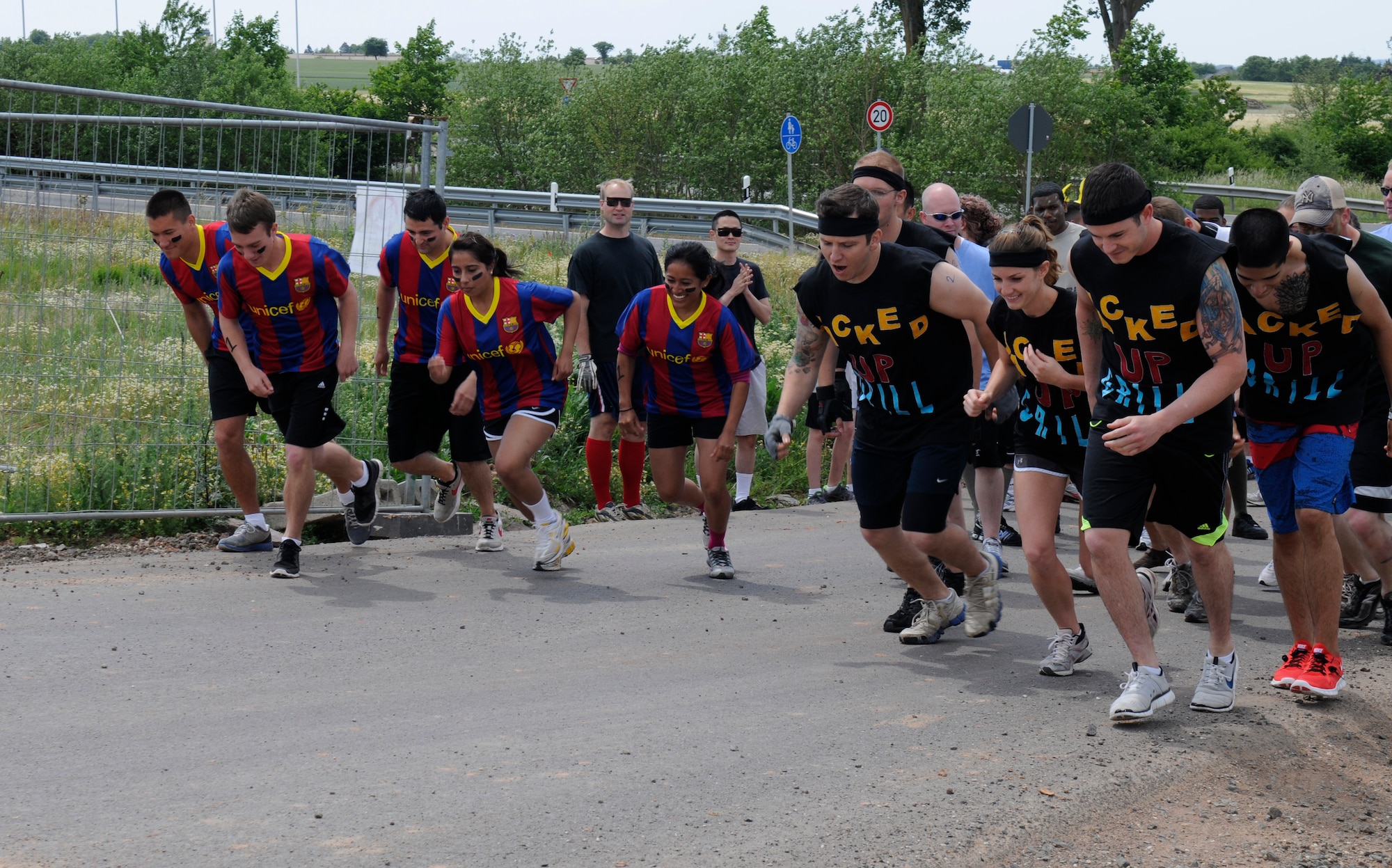 SPANGDAHLEM AIR BASE, Germany – Competitors sprint from the starting line during the Saber Endurance Challenge here June 3. Teams of five were judged on team creativity, guessing their time and money raised. Students from Bitburg High School guessed their time closest within four minutes of estimated completion. Team Soup Kitchen from the 52nd Equipment Maintenance Squadron was awarded most creative, and Team MDSS from the 52nd Medical Group raised the most money. The challenge was hosted by the Tier II council and raised money for the Wounded Warrior Project at Landstuhl Regional Medical Center, Germany. (U.S. Air Force photo/Airman 1st Class Brittney Frees)
