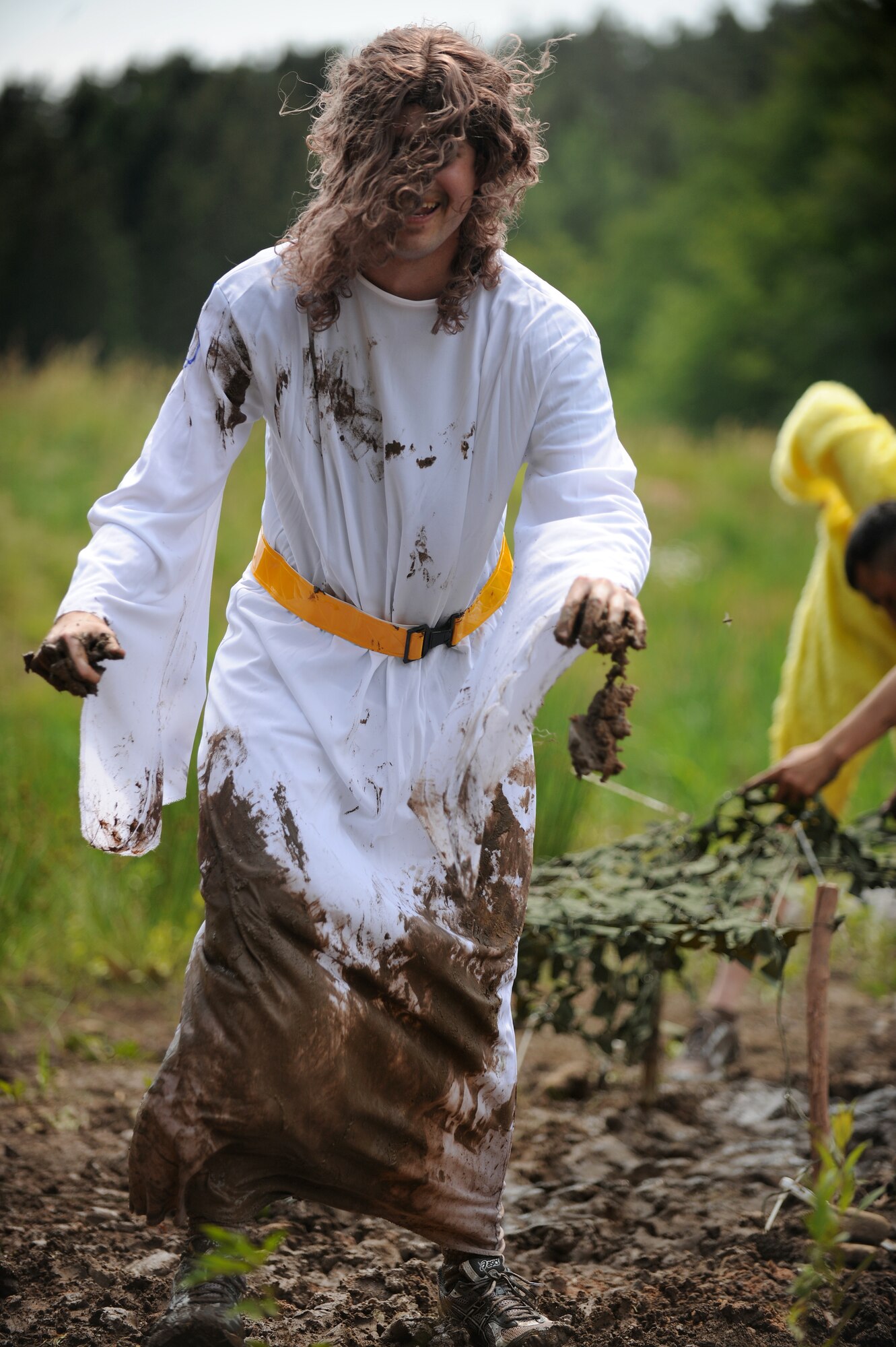 SPANGDAHLEM AIR BASE, Germany – Bryan Dukes, 52nd Equipment Maintenance Squadron, laughs after running through a mud obstacle during the Saber Endurance Challenge here June 3. Teams of five were judged on team creativity, guessing their time and money raised. Students from Bitburg High School guessed their time closest within four minutes of estimated completion. Team Soup Kitchen was awarded most creative, and Team MDSS from the 52nd Medical Group raised the most money. The challenge was hosted by the Tier II council and raised money for the Wounded Warrior Project at Landstuhl Regional Medical Center, Germany. (U.S. Air Force photo/Senior Airman Nathanael Callon)