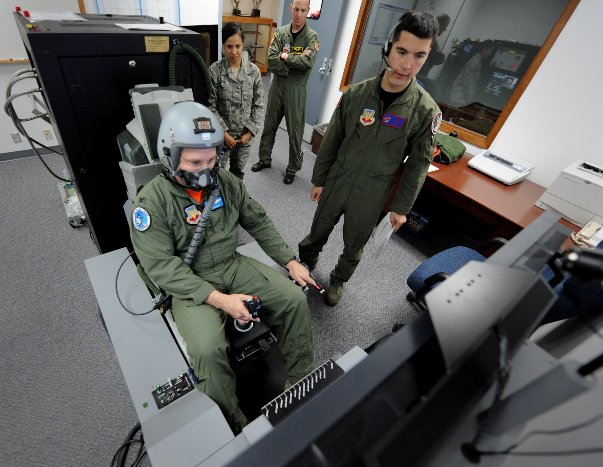 MOUNTAIN HOME AIR FORCE BASE, Idaho – Col. Ron Buckley, 366th Fighter Wing commander, flies a simulated mission while Maj. Joseph Pugliese, 366th Medical Group Aerospace and Operational Physiologist, provides scenarios here June 3. Colonel Buckley is performing his hypoxia training on a new Reduced Oxygen Breathing Device that allows a more realistic experience than the standard altitude chamber. (U.S. Air Force photo by Staff Sgt. Gina Chiaverotti-Paige)