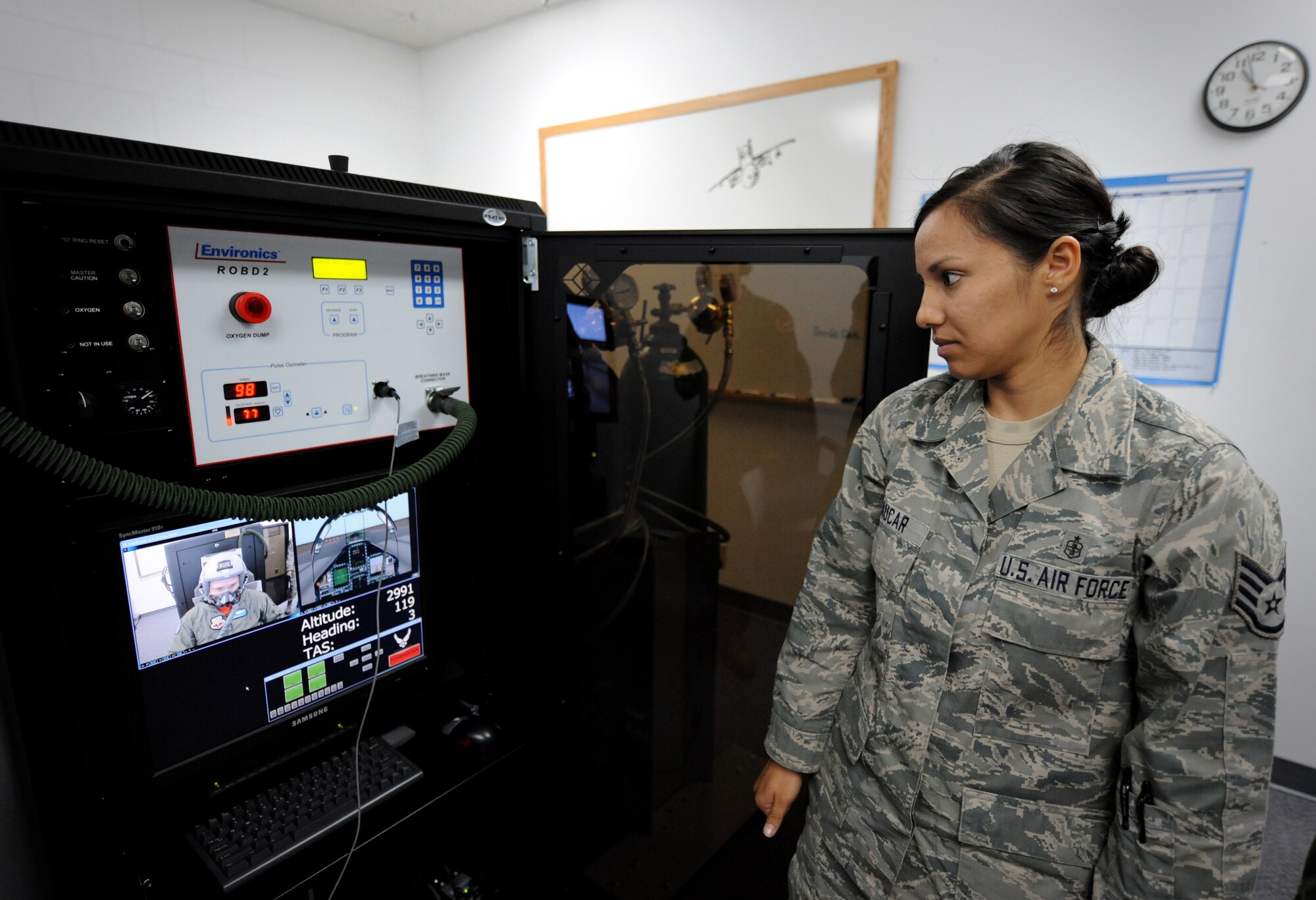 MOUNTAIN HOME AIR FORCE BASE, Idaho – Staff Sgt. Maria Paucar, 366th Medical Group Aerospace and Operations technician, watches vitals and stats while Col. Ron Buckley, 366th Fighter Wing commander, simulates flying on a Reduced Oxygen Breathing Device here June 3. Air Combat Command has reduced costs by replacing the altitude chamber with this new device that takes less time and can be housed at any base. (U.S. Air Force photo by Staff Sgt. Gina Chiaverotti-Paige)