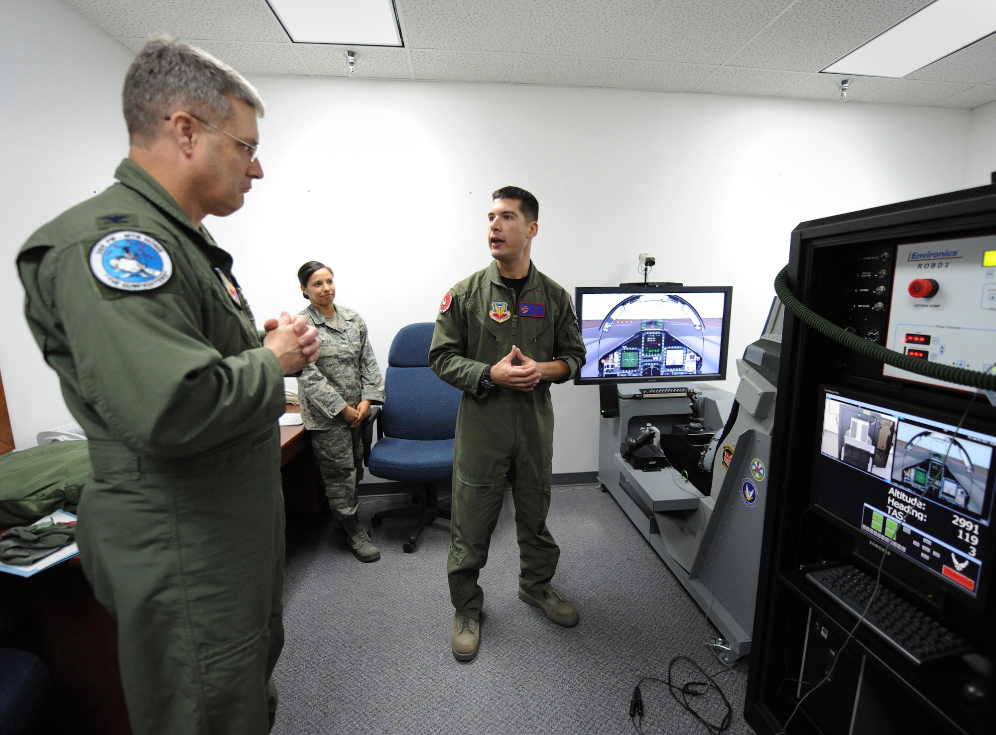 MOUNTAIN HOME AIR FORCE BASE, Idaho – Maj. Joseph Pugliese, right, 366th Medical Group Aerospace and Operational Physiologist, briefs Col. Ron Buckley, 366th Fighter Wing commander, on the Reduced Oxygen Breathing Device here June 3. The device allows pilots and weapons system officers to experience the effects of hypoxia, which is a lack of oxygen in the body that can result in unconsciousness. (U.S. Air Force photo by Staff Sgt. Gina Chiaverotti-Paige)