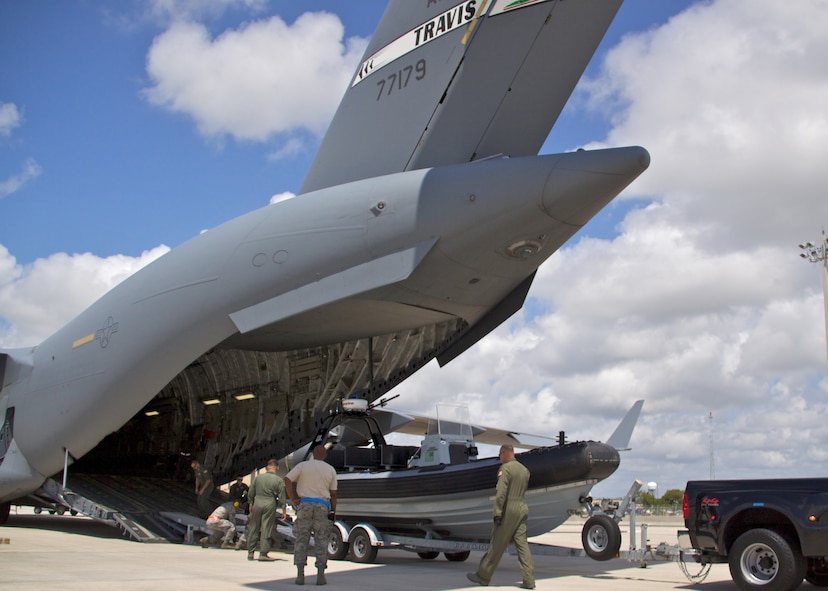 Members of the 70th Aerial Port Squadron work with members of the F.B.I. and a C-17 crew from Travis AFB while conducting training at Homestead ARB, Saturday, June 5, 2011. A variety of vehicles were loaded, including a boat, a HMMWV and a sport utility vehicle. Crews must be versed in a variety of equipment to address needs of multiple stateside and deployed missions. (US Air Force photo/Tech. Sgt. Lionel Castellano)