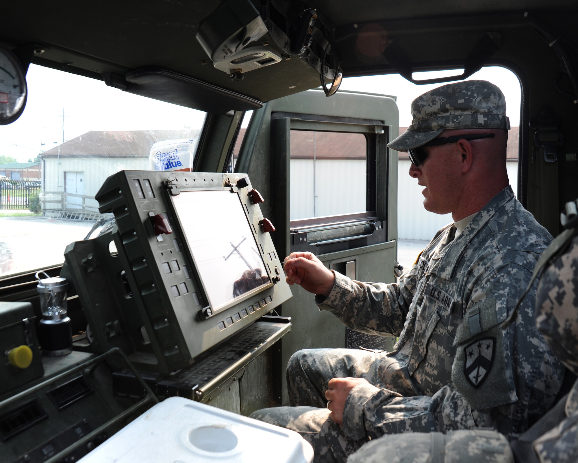 Staff Sgt. Jeremy Coleman, A Battery, 1/181st Field Artillery Battalion, demonstrates how to use the GPS aided navigation system inside one of the HIMARS, June 4, 2011.