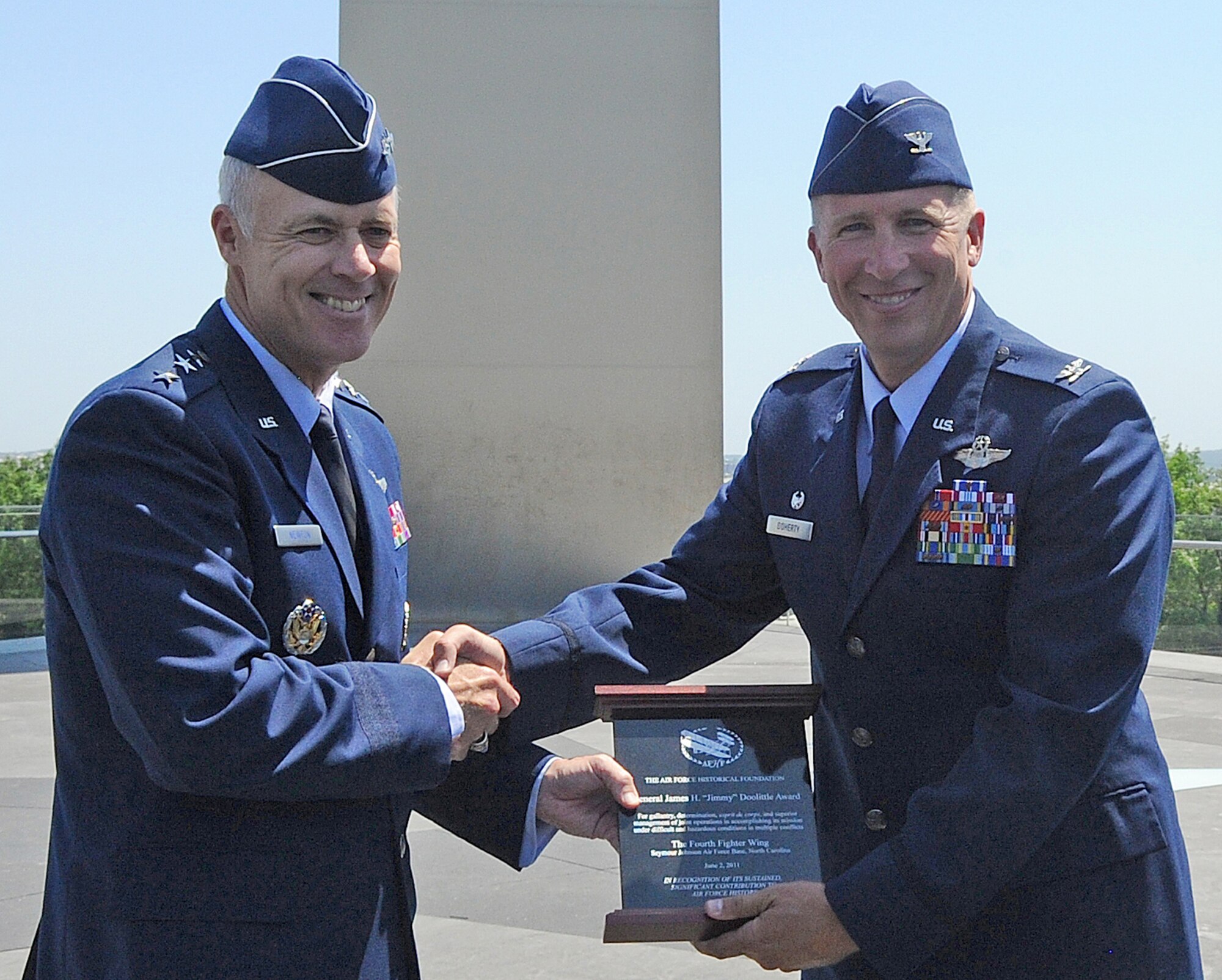 U.S. Air Force Assistant Vice Chief of Staff Lt. Gen. Richard Newton III presents Col. Patrick Doherty with the inaugural Doolittle Award June 2, 2011, at the Air Force Memorial in Arlington, Va. The Air Force Historical Foundation Doolittle Award recognizes a unit that has displayed bravery, determination, discipline, esprit de corps and superior management of joint operations while accomplishing its mission under extremely difficult and hazardous conditions in multiple conflicts, making a sustained, significant contribution to Air Force history. Colonel Doherty is the commander of the 4th Fighter Wing, and accepted the award on behalf of the wing. (U.S. Air Force photo/Senior Airman Gino Reyes)