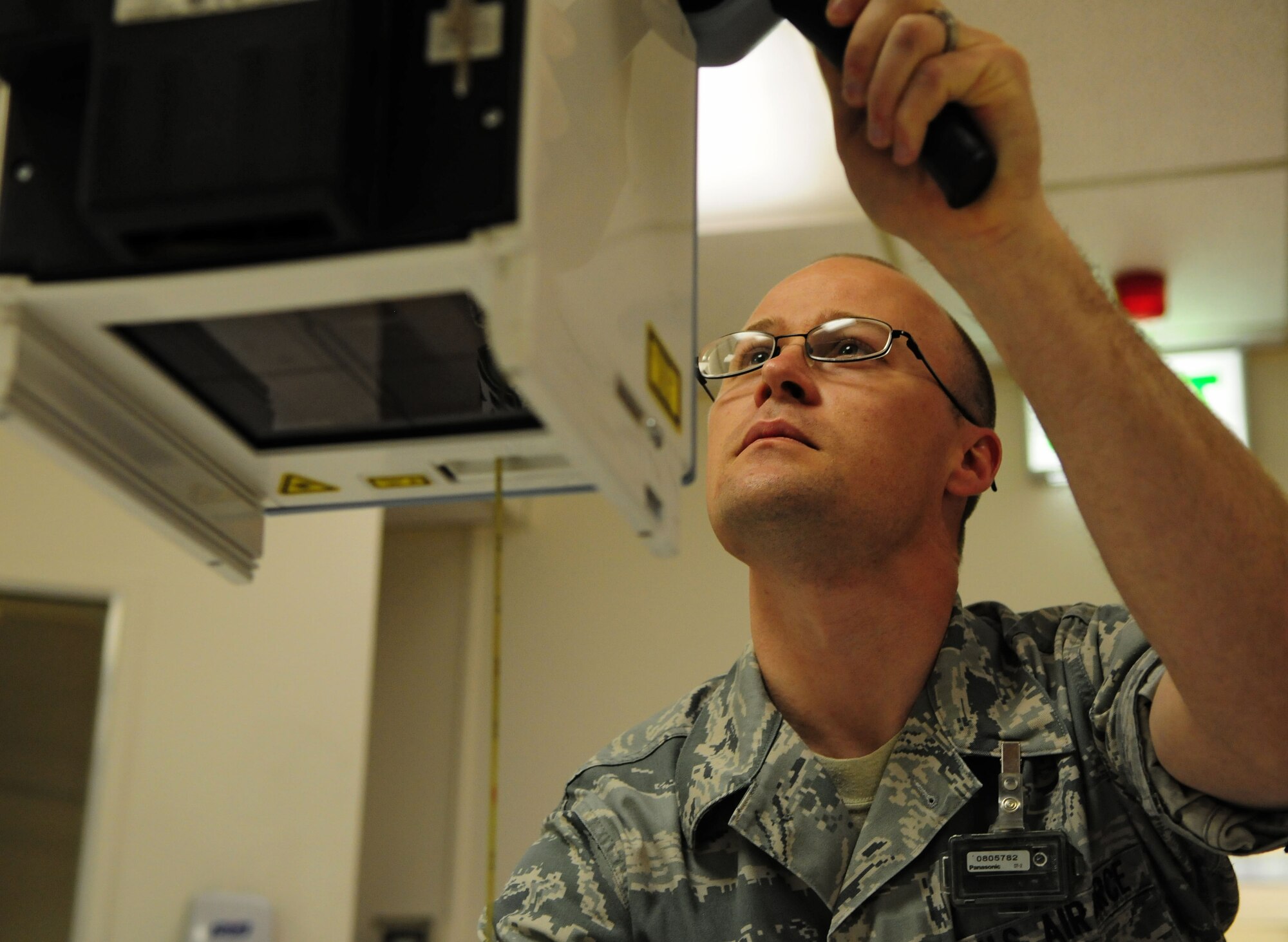 SPANGDAHLEM AIR BASE, Germany – Staff Sgt. Christopher Pundsack, 52nd Medic al Support Squadron ultrasound technician, adjusts a radiographic unit to take an X-ray of a patient here June 2. The X-ray will aid the physicians in diagnosing medical conditions the patient may have. (U.S. Air Force photo/Airman 1st Class Matthew B. Fredericks)