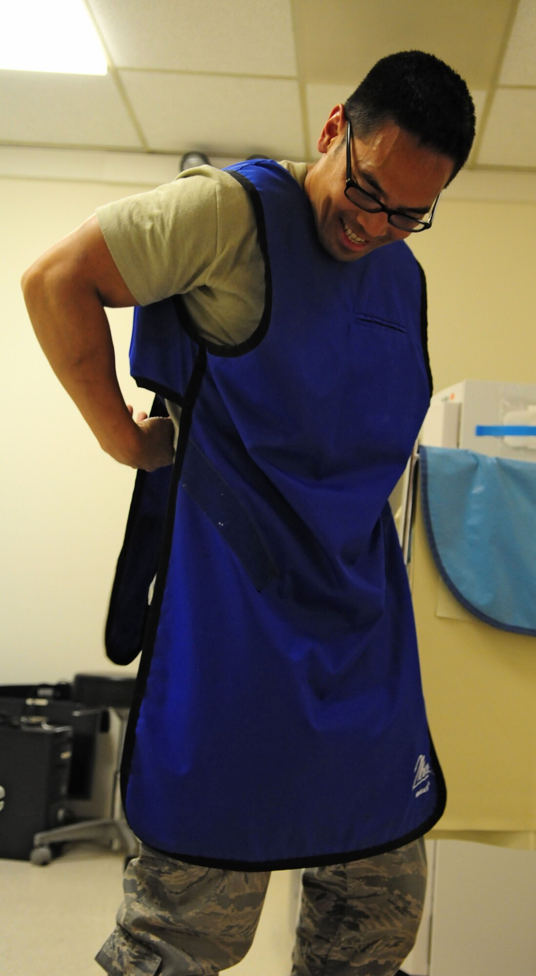 SPANGDAHLEM AIR BASE, Germany – Master Sgt. Mark Martinez, 52nd Medical Support Squadron diagnostic imaging flight chief, puts on a lead apron while working in the radiology office here June 2. The office takes X-rays and ultrasounds to aid physicians in diagnosing medical conditions patients may have. (U.S. Air Force photo/Airman 1st Class Matthew B. Fredericks)