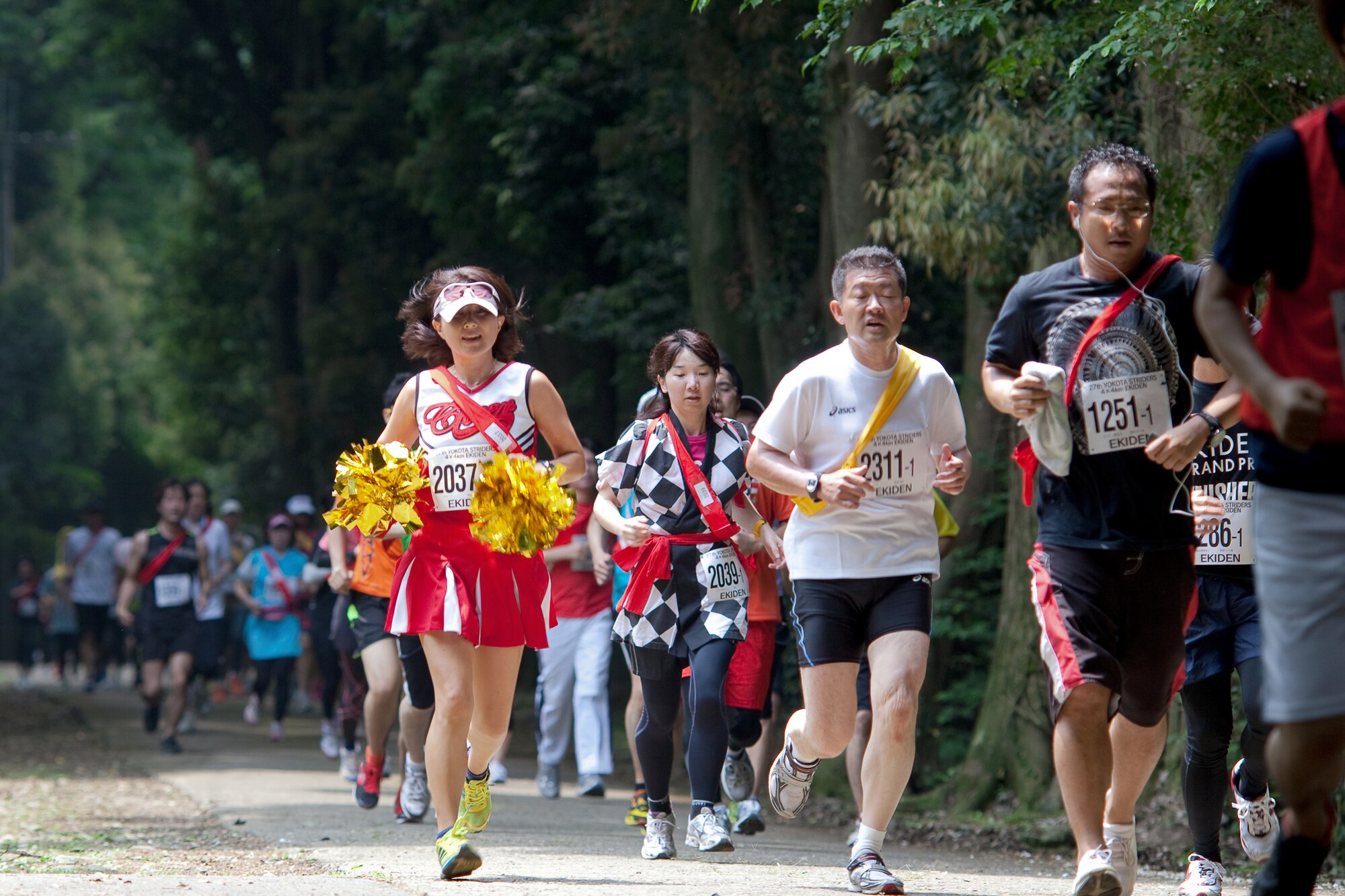 INAGI CITY, Japan -- A runner dressed as a cheerleader participates in the 27th Yokota Ekiden at the Tama Hills Recreation Area June 5, 2011. This is the first time the race was hosted at Tama Hills and more than 4,000 runners participated in the 2K kid's run, the 5K, and the 4x4 kilometer Ekiden relay main event. (U.S. Air Force photo/Osakabe Yasuo)