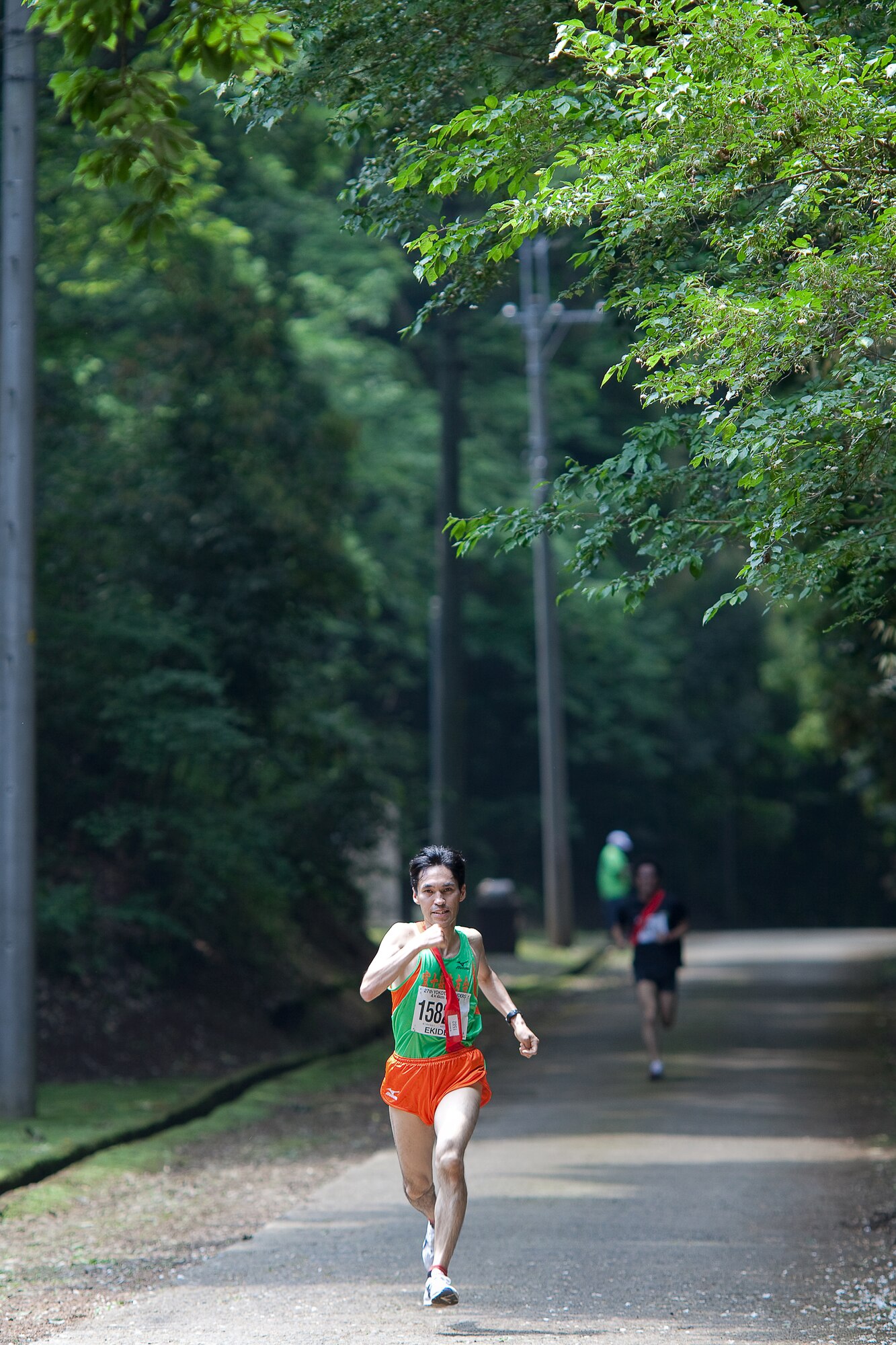 INAGI CITY, Japan -- The Yokota Striders Running Club sponsored the 27th Yokota Ekiden at the Tama Hills Recreation Area June 5, 2011. This is the first time the race was hosted at Tama Hills. More than 4,000 runners participated in the 2K kid's run, the 5K, and the 4x4 kilometer Ekiden relay main event. Hirohiko Kumazawa and his team received second place of 4x4km Ekiden, finishing with a time of 0:56:01. (U.S. Air Force photo/Osakabe Yasuo)