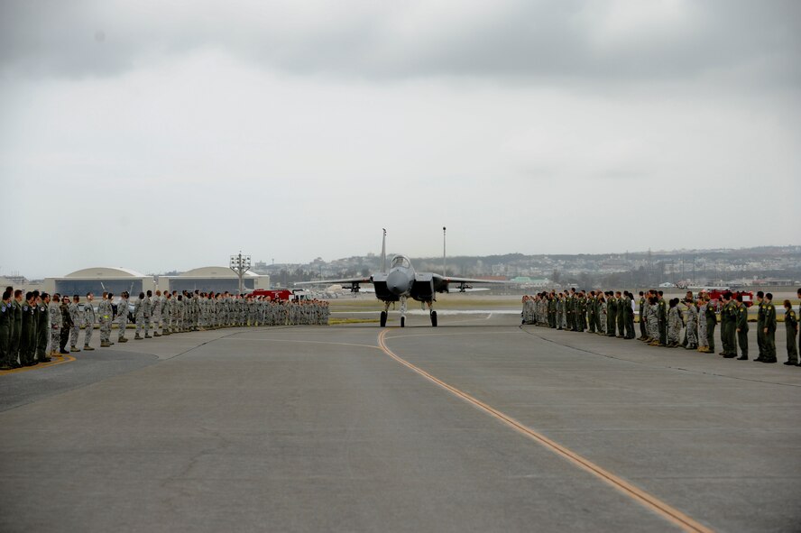 Brig. Gen. Ken Wilsbach, 18th Wing commander, taxies through a cordon of Airmen from the 18th Wing in an F-15 Eagle after his “fini-flight,” June 1. General Wilsbach is preparing to leave Kadena following his change of command ceremony June 3 to assume the position of Deputy Director for Operations, Headquarters United States Pacific Command, Camp H.M. Smith, Hawaii. (U.S. Air Force photo/Staff Sgt. Jonathan Steffen)