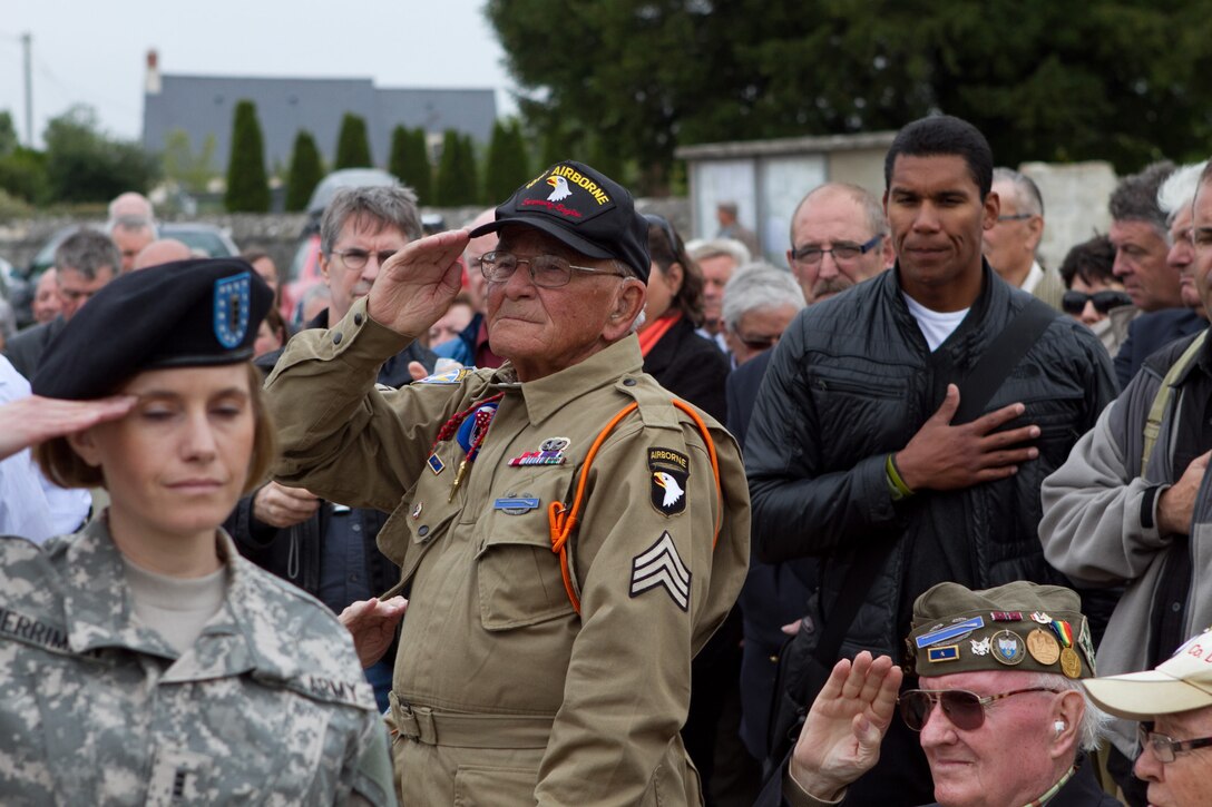 A World War II veteran and former paratrooper with the 101st Airborne Division salutes the U.S. flag during a memorial ceremony held June 4, 2011, to honor his fallen comrades who died liberating Angoville au Plain, France, and surrounding areas following the Allied invasion of Normandy in 1944. Residents of Angoville hold the memorial ceremony every year. U.S. Army photo by Sgt. Michael J. MacLeod
