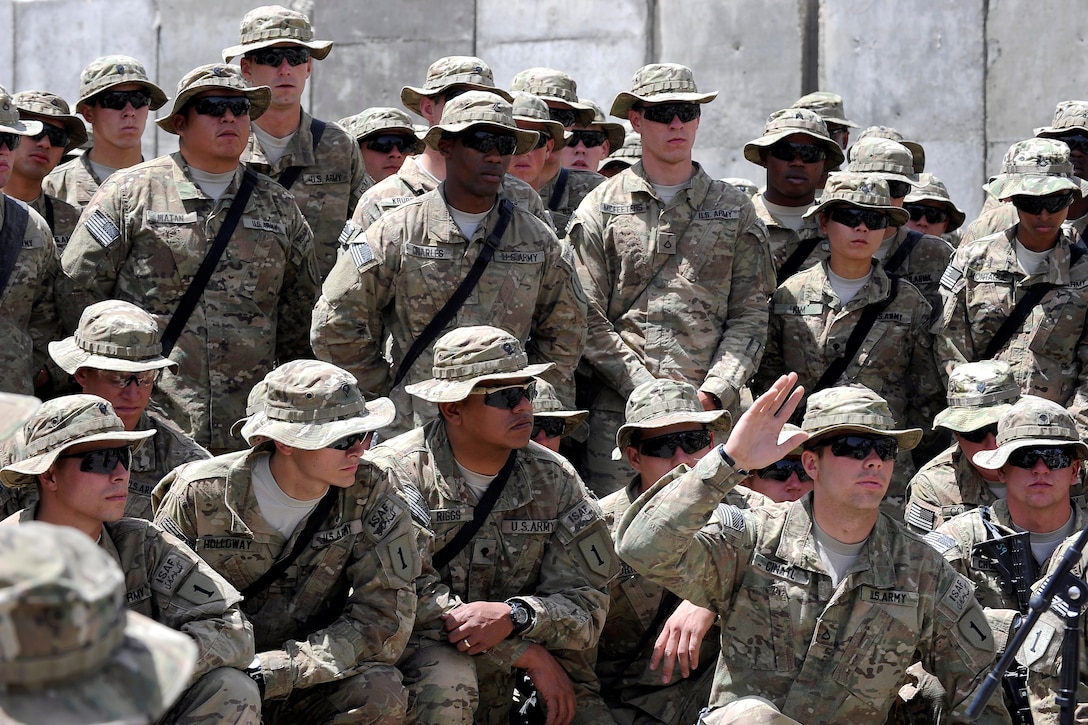 A U.S. Army soldier raises his hand to ask a question of U.S. Defense Secretary Robert M. Gates at a forward operating base in Afghanistan, June 6, 2011.