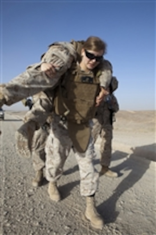 U.S. Marine Corp Cpl. Kelly Campagna, assigned to Marine Aviation Logistics Squadron 40, performs a fireman's carry with Cpl. Lance Rowewood during a corporal's course five mile hike from Camp Leatherneck to Camp Bastion, Helmand province, Afghanistan, on May 30, 2011.  The final phase in graduating from the corporal's course was a five mile trek that implemented various obstacles.  