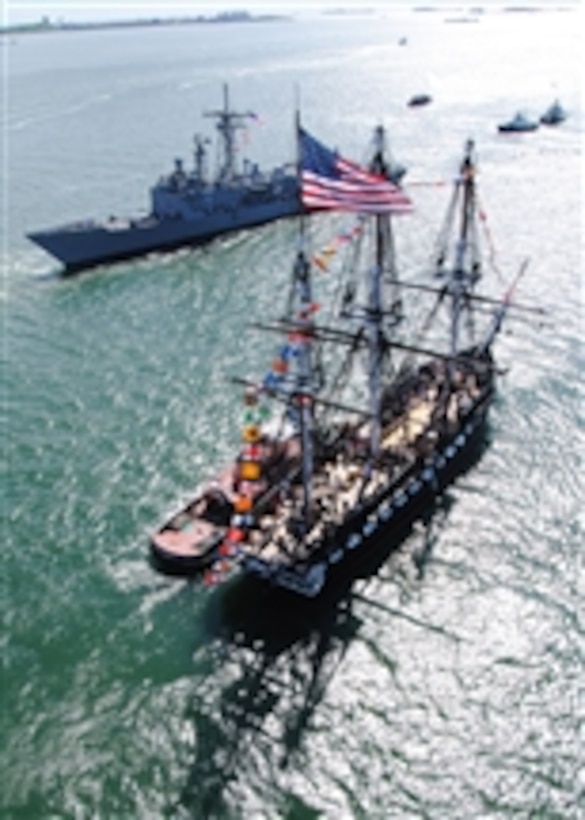 The USS Constitution greets the guided-missile frigate USS Carr (FFG 52) in Boston Harbor during an underway Battle of Midway commemoration on June 3, 2011.  The underway honored approximately 200 members of Gold Star Families who lost loved ones in Operations Enduring and Iraqi Freedom and remembered the Navy's victory at Midway Island in World War II.  