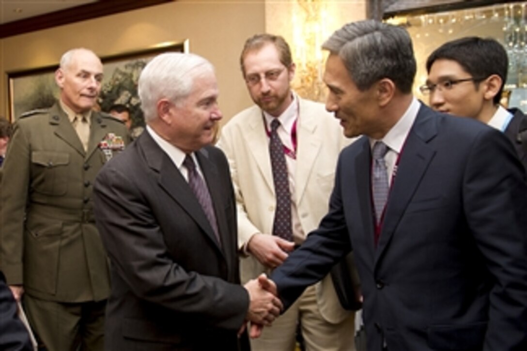 Secretary of Defense Robert M. Gates shakes hands with South Korean Defense Minister Lee Yong-gul during the 10th International Institute for Strategic Studies Asia Security Summit at the Shangri-La Hotel in Singapore on June 4, 2011.  