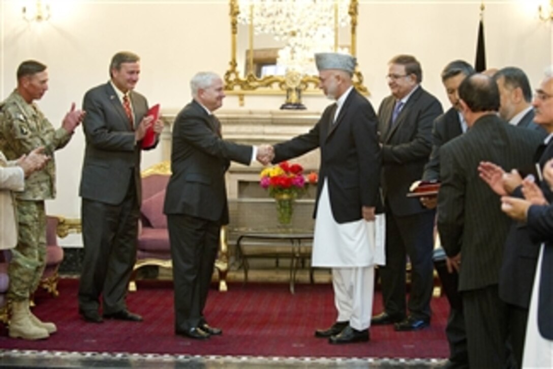 President of Afghanistan Hamid Karzai presents Secretary of Defense Robert M. Gates with the Ghazi Wazir Mohammad Akbar Khan Medal, Afghanistan's highest governmental award, in Kabul, Afghanistan, on June 4, 2011.  