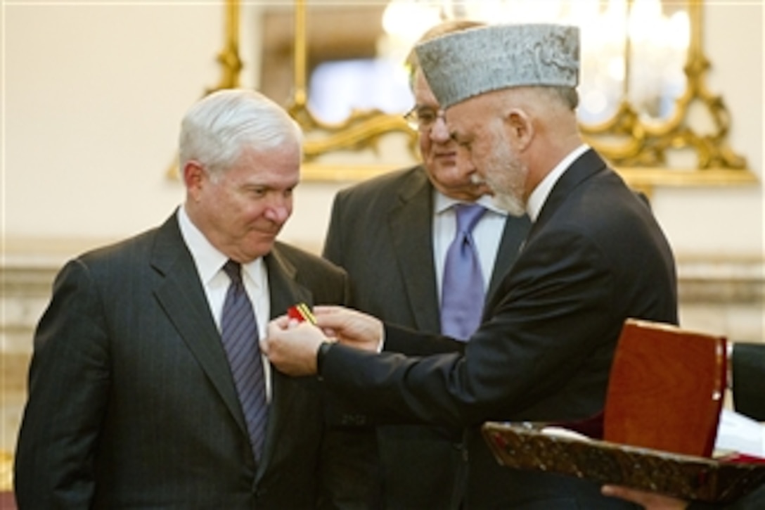 President of Afghanistan Hamid Karzai presents Secretary Gates with the