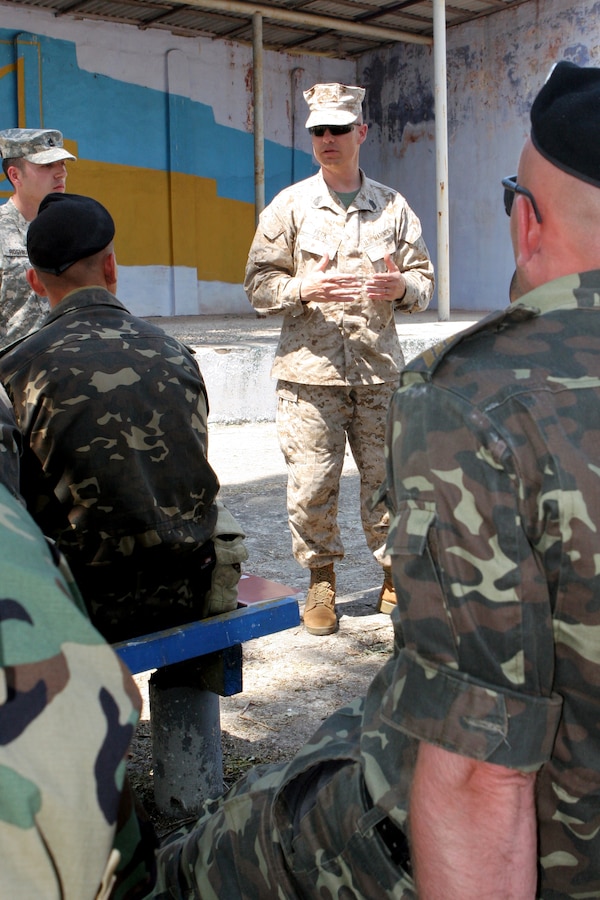 Staff Sgt. Michael Heller, a member of the Security Cooperation team, U.S. Marine Corps Forces, South, assists with building targets for the range during a Security Cooperation engagement with Cuerpo Infanteria de Marina (CIM) of Panama's National Sea and Air Service (SENAN), June 4, 2011.  (Official USMC photo/released)