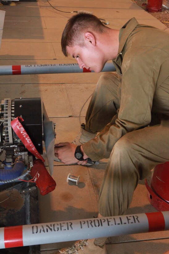 Cpl. Joshua A. Legnosky, a unmanned aerial vehicle technician with Marine Unmanned Aerial Vehicle Squadron 3, and a native of Olivehurst, Calif., cuts wire attached to the rotor of an RQ-7B Shadow unmanned aerial vehicle at Camp Dwyer, Afghanistan, June 7. Deployed Marine Corps UAV squadrons use small, lightweight vehicles that are able to stay in the air for several hours to supply Marines and their coalition partners with aerial information throughout combat missions.