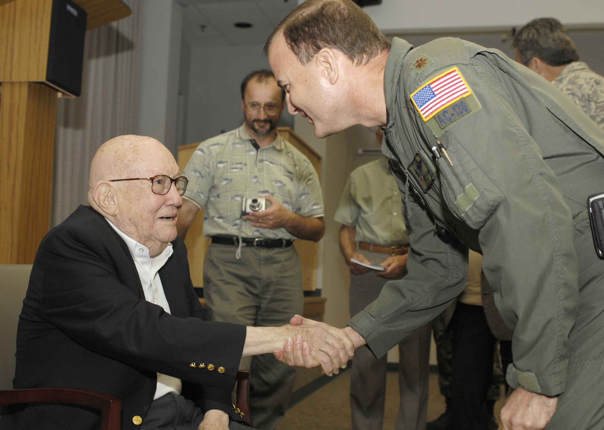 Retired Maj. Gen. John Alison (left), the deputy commander of the 1st Air Commando Group in 1943, is greeted by Maj. Brian Strang (right), of Headquarters Air Force Special Operations Command, after the general's presentation May 6, 2008, at the U.S. Air Force Special Operations School at Hurlburt Field, Fla. (U.S. Air Force photo/Airman 1st Class Jason Epley)