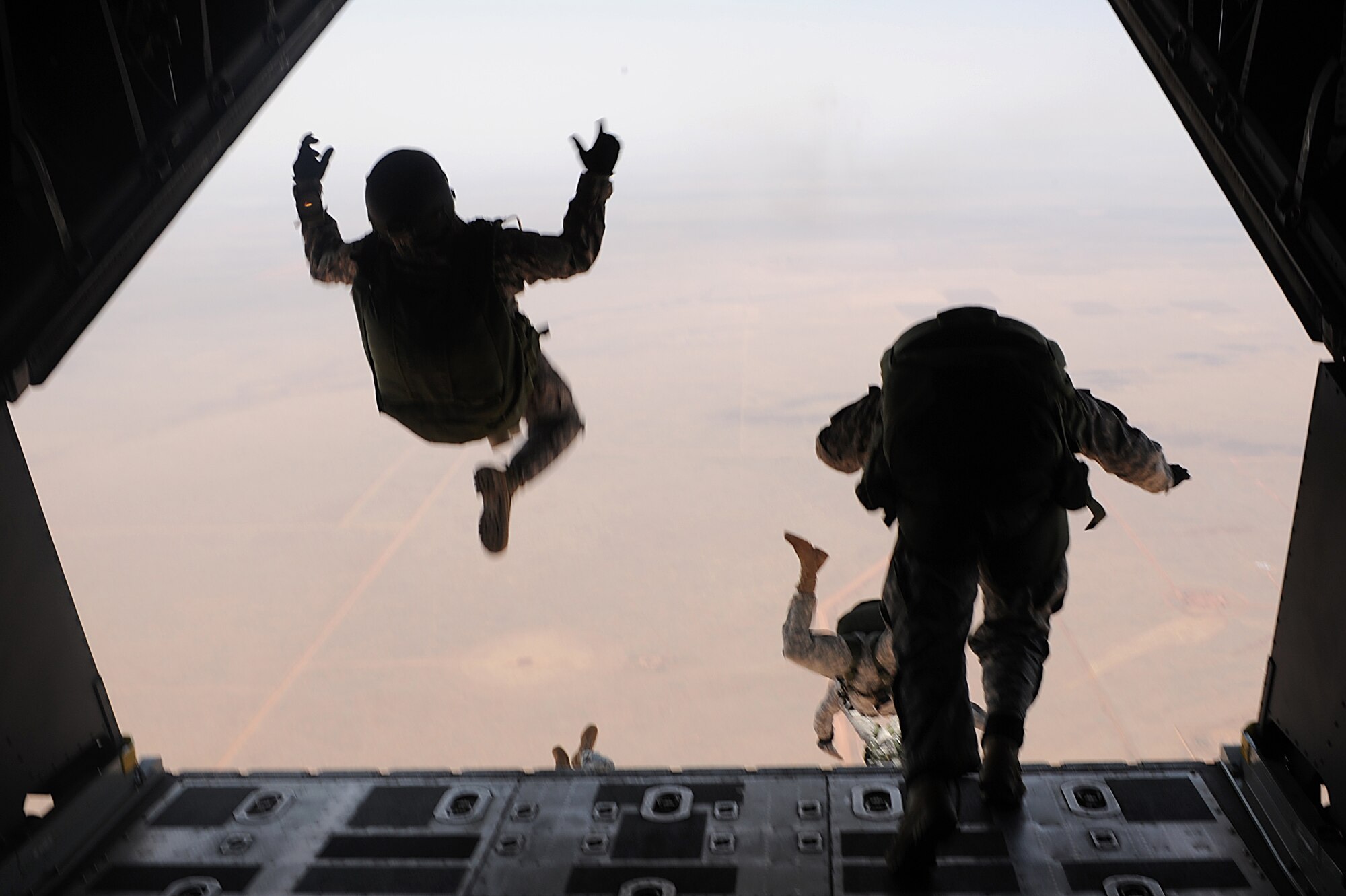 Special operations forces jump out of a MC-130W Dragon Spear flown by the 73rd Special Operations Squadron over Melrose Air Force Range during the 27th Special Operations Wing Capabilities Exercise, June 4, 2011.  Parachutists were one of many aerial and ground attractions of the CAPEX, which is an annual exhibition of the 27 SOW's many special operations aircraft and missions for Cannon Airmen and their families.  (U.S. Air Force photo by Senior Airman James Bell)(RELEASED)