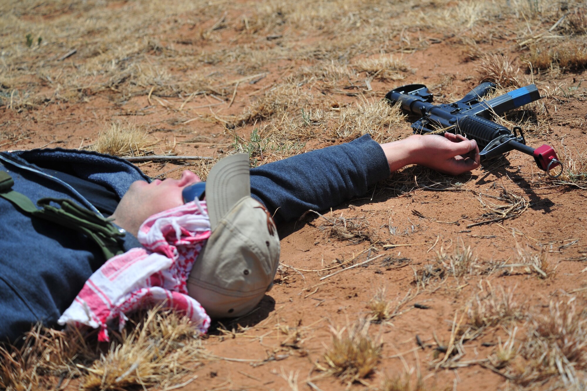 A volunteer poses as an opposition force casualty as part of an aerial and ground demonstration for around 600 spectators at the 27th Special Operations Wing Capabilities Exercise, June 4, 2011, at Melrose Air Force Range. The CAPEX is an annual exhibition of the 27 SOW's many special operations aircraft and missions for Cannon Airmen and their families. (US Air Force Photo by Tech. Sgt. Josef Cole)(RELEASED)
