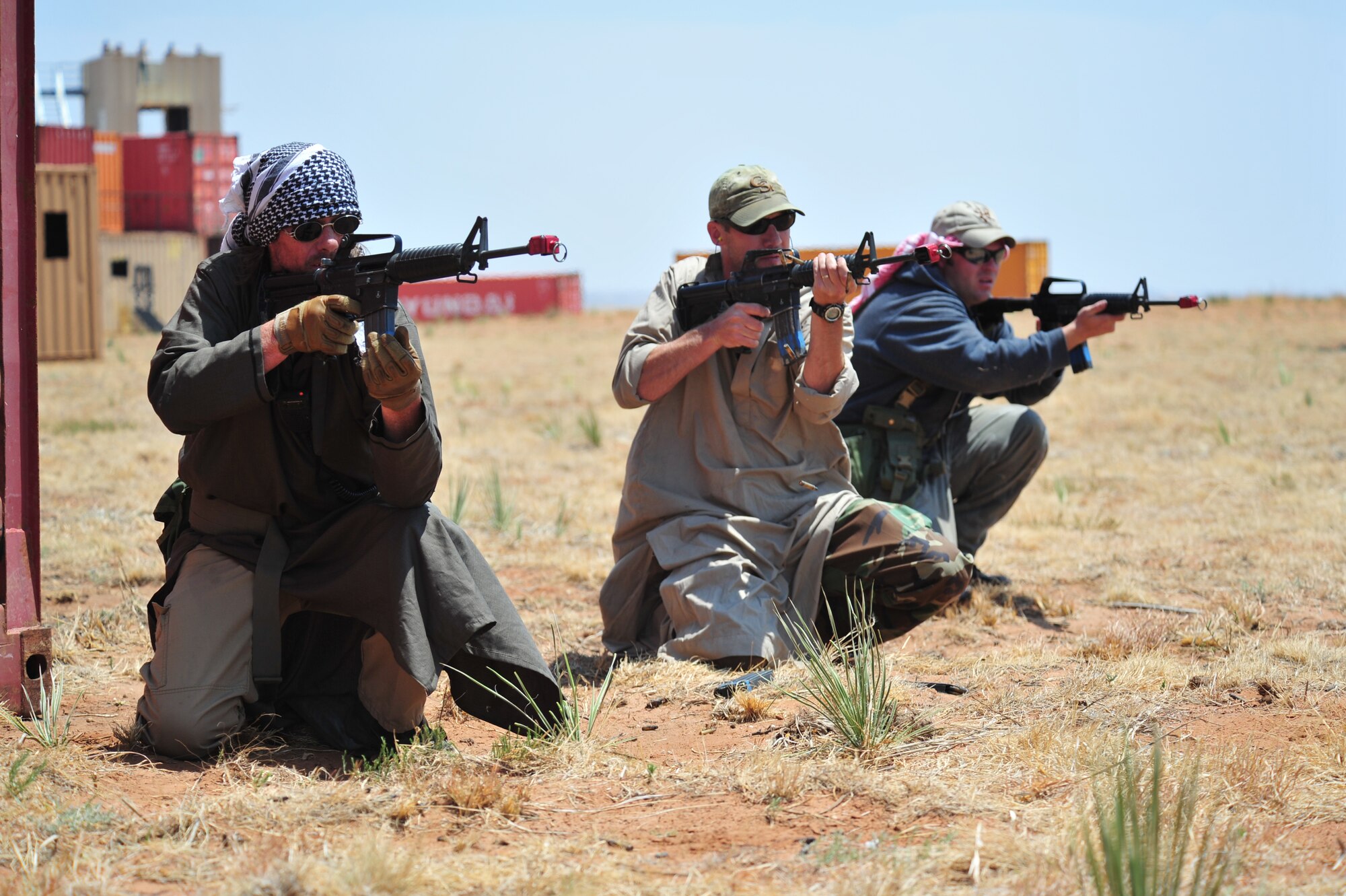 Volunteers pose as opposition forces as part of an aerial and ground demonstration for around 600 spectators at the 27th Special Operations Wing Capabilities Exercise, June 4, 2011, at Melrose Air Force Range. The CAPEX is an annual exhibition of the 27 SOW's many special operations aircraft and missions for Cannon Airmen and their families. (U.S. Air Force photo by Tech. Sgt. Josef Cole)(RELEASED)
