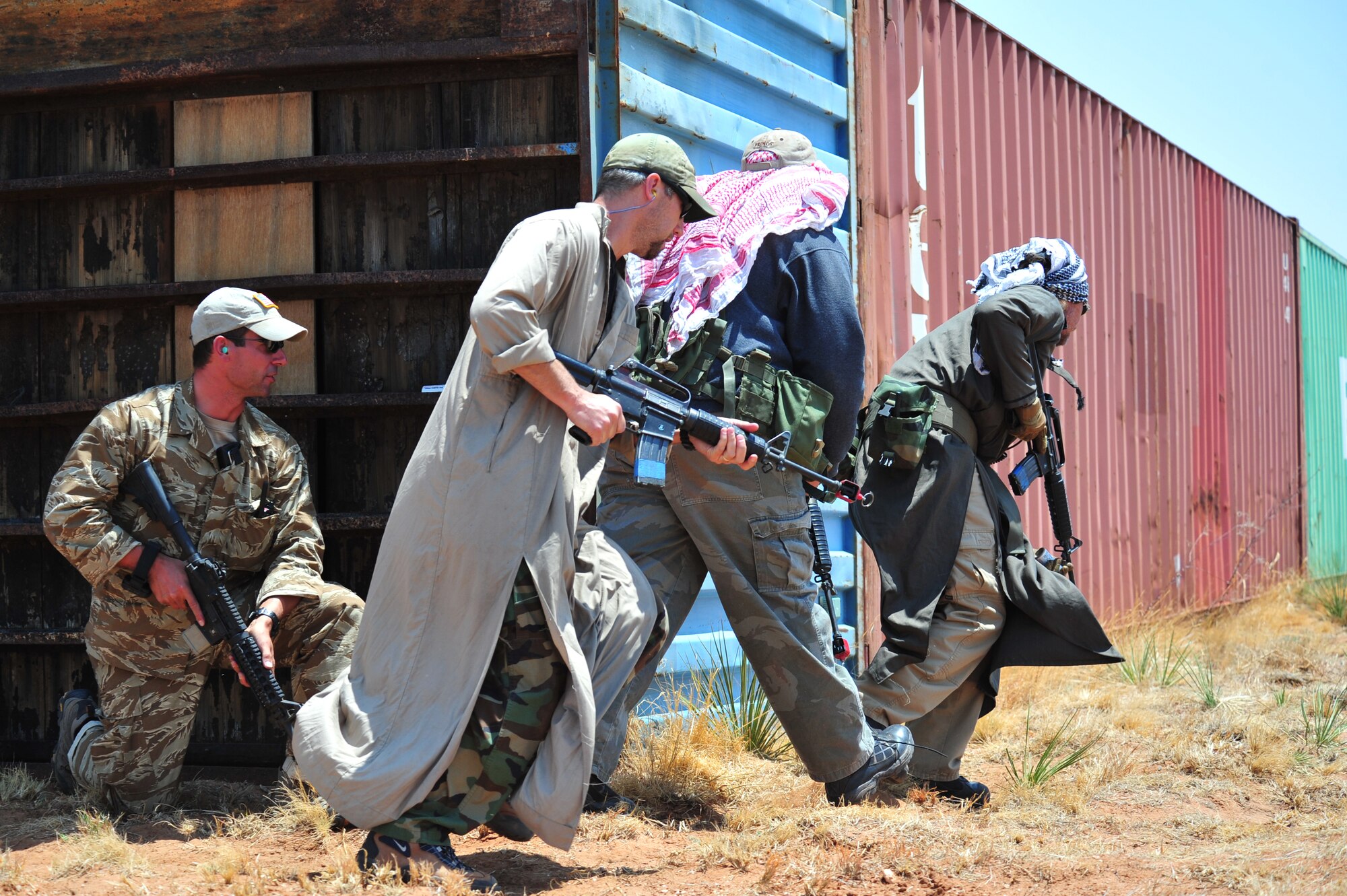 Volunteers pose as opposition forces as part of an aerial and ground demonstration for around 600 spectators at the 27th Special Operations Wing Capabilities Exercise, June 4, 2011, at Melrose Air Force Range. The CAPEX is an annual exhibition of the 27 SOW's many special operations aircraft and missions for Cannon Airmen and their families. (U.S. Air Force photo by Tech. Sgt. Josef Cole)(RELEASED)