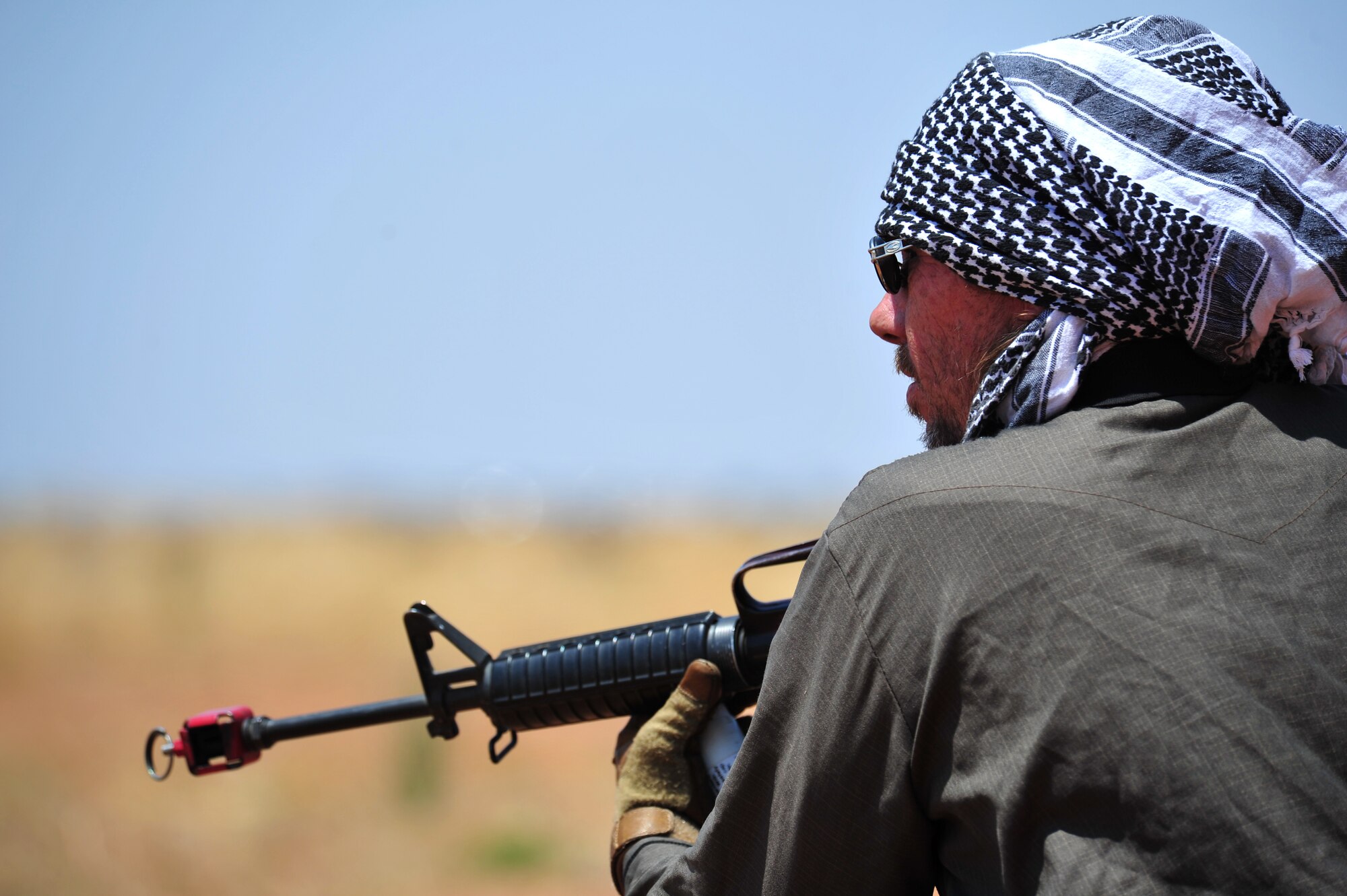 a volunteer poses as the opposition force as part of an aerial and ground demonstration for around 600 spectators at the 27th Special Operations Wing Capabilities Exercise, June 4, 2011, at Melrose Air Force Range. The CAPEX is an annual exhibition of the 27 SOW's many special operations aircraft and missions for Cannon Airmen and their families. (U.S. Air Force photo by Tech. Sgt. Josef Cole)(RELEASED)