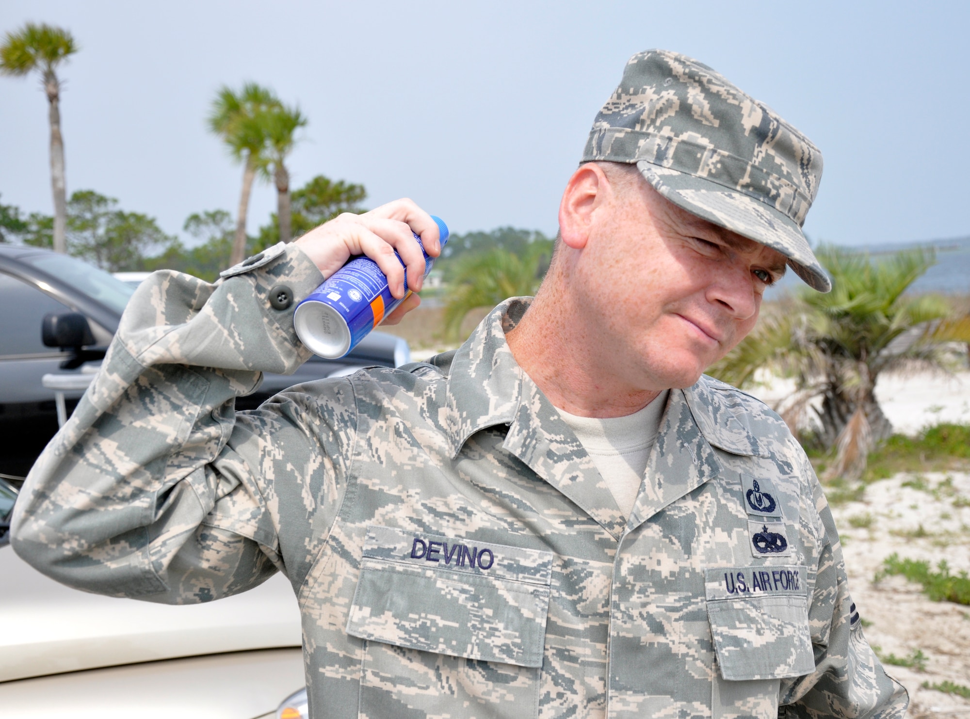 Master Sgt. Russell Devino, 1st Special Operations Wing Ground Safety superintendent, sprays sunscreen on his neck at the Soundside Beach at Hurlburt Field, Fla., June 7, 2011. Applying sunscreen can play a major role in protecting the skin from ultraviolet radiation. (U.S. Air Force photo by Senior Airman Joe McFadden / RELEASED)
