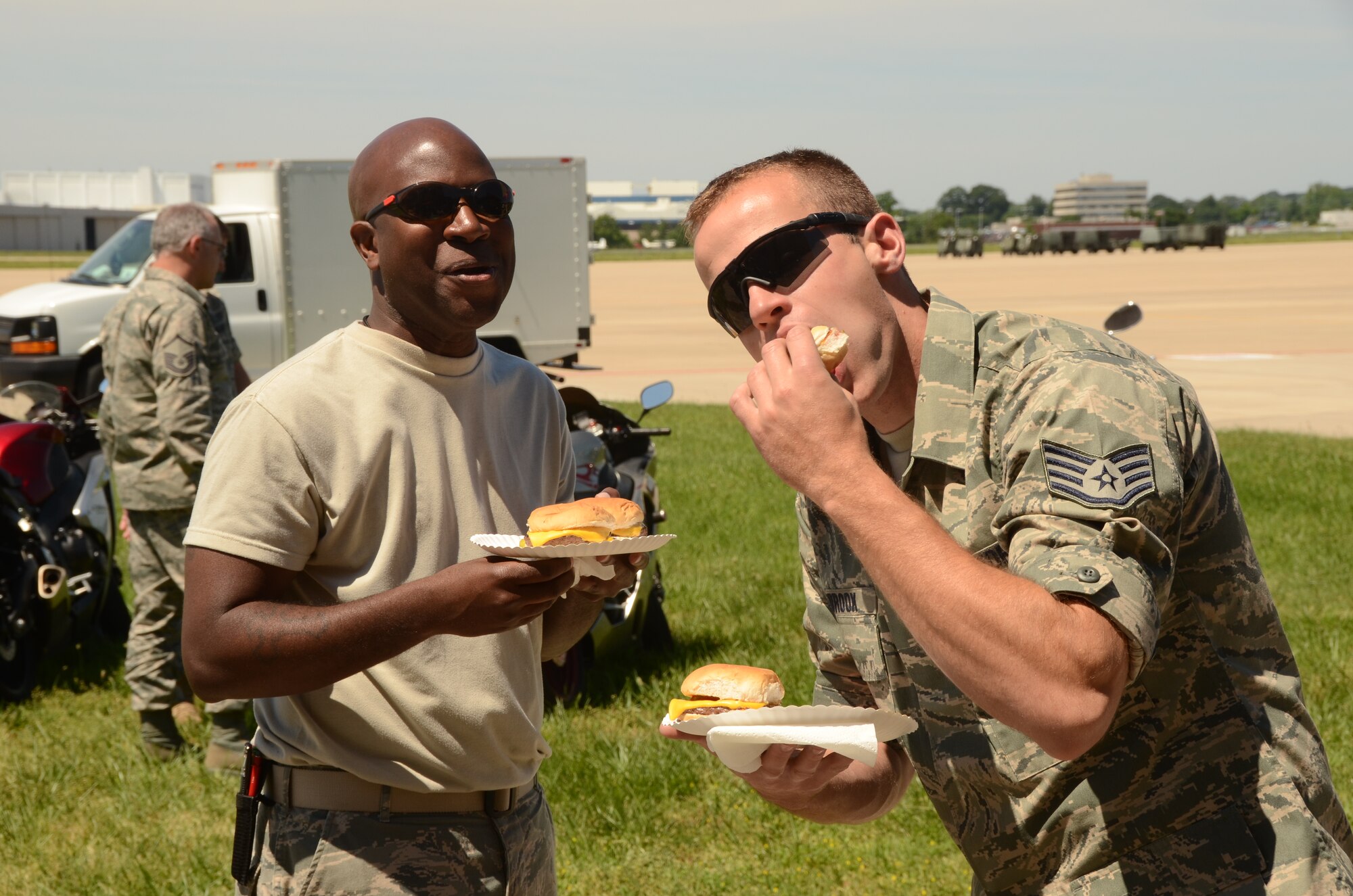 (Left to right) Staff Sgts. Gary Oliver and Mike Ashbrook, both are weapon loading crew chiefs on the A-10C. They chow down on the burgers at the charity cookout at Warfield Air National Guard Base in Baltimore, Md., June 3, 2011. The charity cookout benefited the Ride Across Maryland which funds breast cancer research. The Maryland Air Guard Riders raised over $2400 for breast cancer research.
