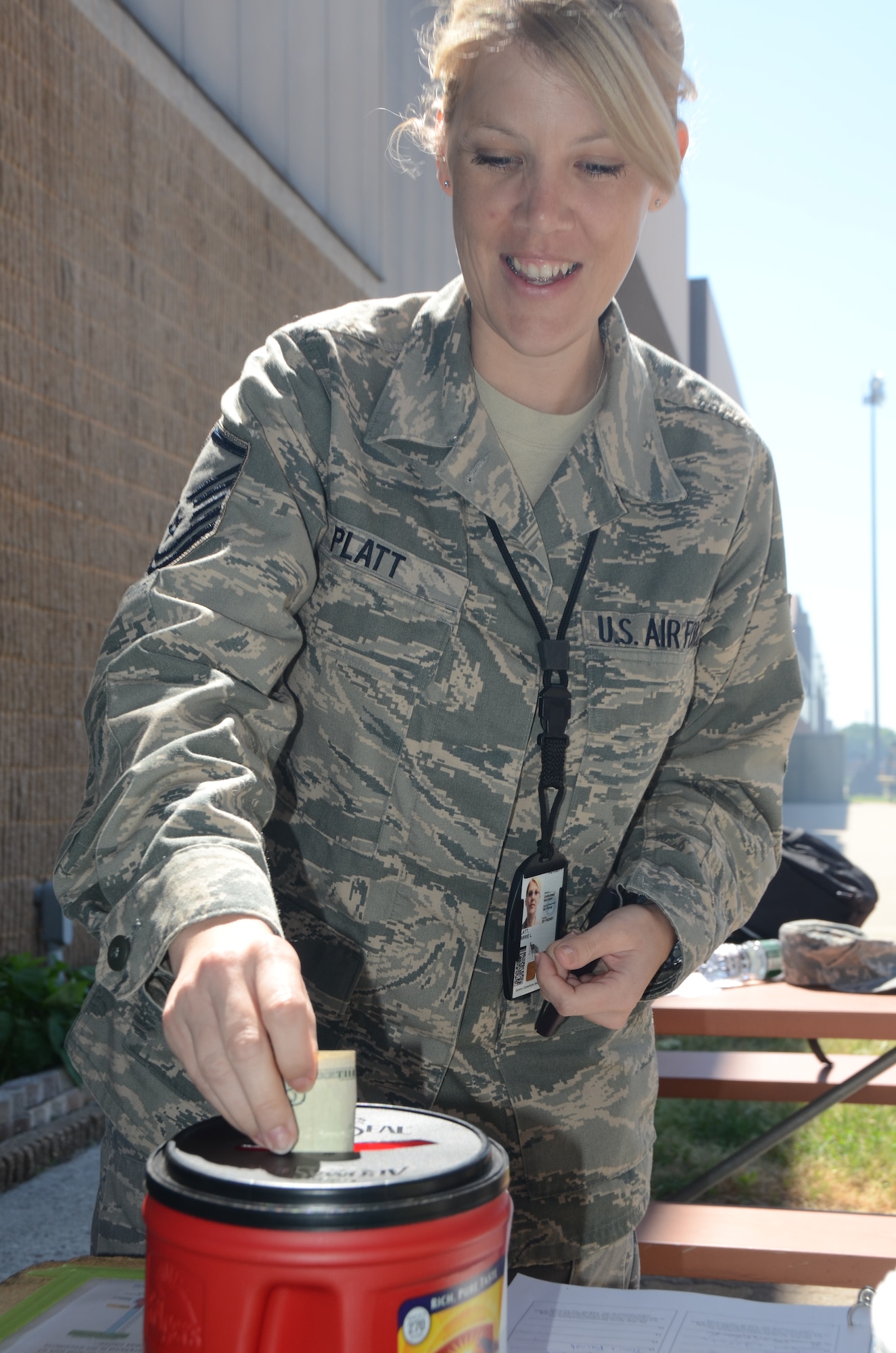 Master Sgt. Carrie Platt, from the Maryland Air National Guard's 135th Airlift Group was one of the first to donate at the charity cookout, she also made an online donation to the Maryland Air Guard Riders.  She donated at Maryland Air National Guard, 175th Wing at Warfield Air National Guard Base in Baltimore, Md., June 3, 2011 charity cookout to benefit the Ride Across Maryland which funds breast cancer research. (U.S. Air Force photo by Master Sgt. Ed Bard/Released)
