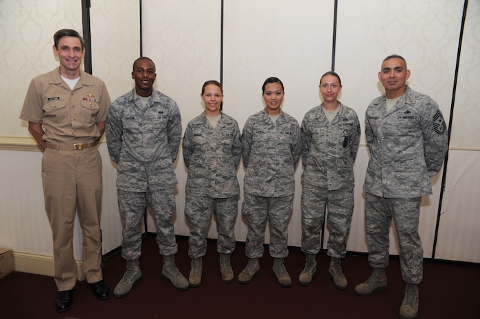 Navy Capt. Ralph Ward and Command Chief Master Sgt. Jose LugoSantiago pose with the June Diamond Sharp Award winners. (Left to right) Airman 1st Class Nathaniel Hopson from the 628th Communication Squadron, Airman1st Class Brandi Hansen from the 1st Combat Camera Squadron, Airman 1st Class Fatima Calisa from the 628th Force Support Squadron and Staff Sgt. Stephanie Pyles from the 628th Civil Engineer Sqaudron. The Diamond Sharp Award is presented to outstanding Airmen chosen by their respective first sergeants. Captain Ward is the Joint Base Charleston deputy commander. (U.S. Air Force photo/ Staff Sgt. Nicole Mickle)  