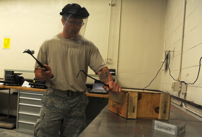 Staff Sgt. David Hardy opens demolition charges on the munitions inspections table at Joint Base Charleston June 2.  Sergeant Hardy is  inspecting the demolition charges prior to shipment to another base. He ensures  all markings and quantities are correct for shipment. Sergeant Hardy works in the 437th Maintenance Squadron's Munition Shop.  (U.S. Air Force photo/ Staff Sgt. Nicole Mickle)  
