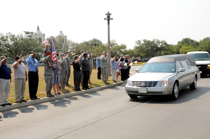 A motorcade processional transporting the remains of Army Sgt. Thomas A. Bohall, of Bel Aire, Kan., travels down Harmon Drive at Randolph Air Force Base, Texas, June 7. Bohall was assigned to the 4th Battalion, 101st Aviation Regiment, 159th Combat Aviation Brigade, 101st Airborne Division (Air Assault), Fort Campbell, Ky. Sergeant Bohall was one of six soldiers from Fort Campbell who were supporting Operation Enduring Freedom and killed by an improvised explosive device during an insurgent attack May 26, 2011 in Kandahar province, Afghanistan.(U.S. Air Force photo/Melissa Peterson)
